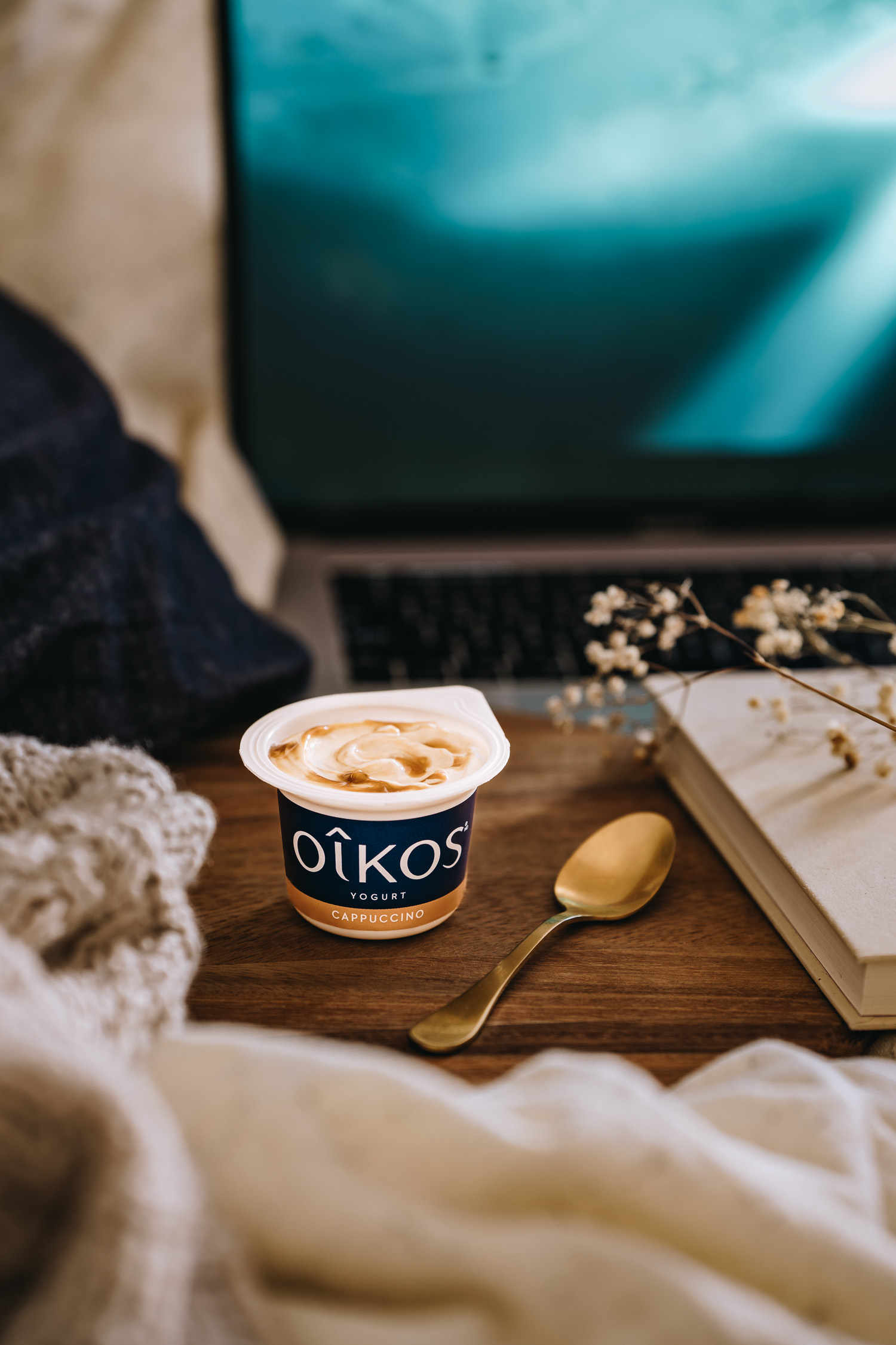 Oikos Cappuccino Yogurt being enjoyed in bed
