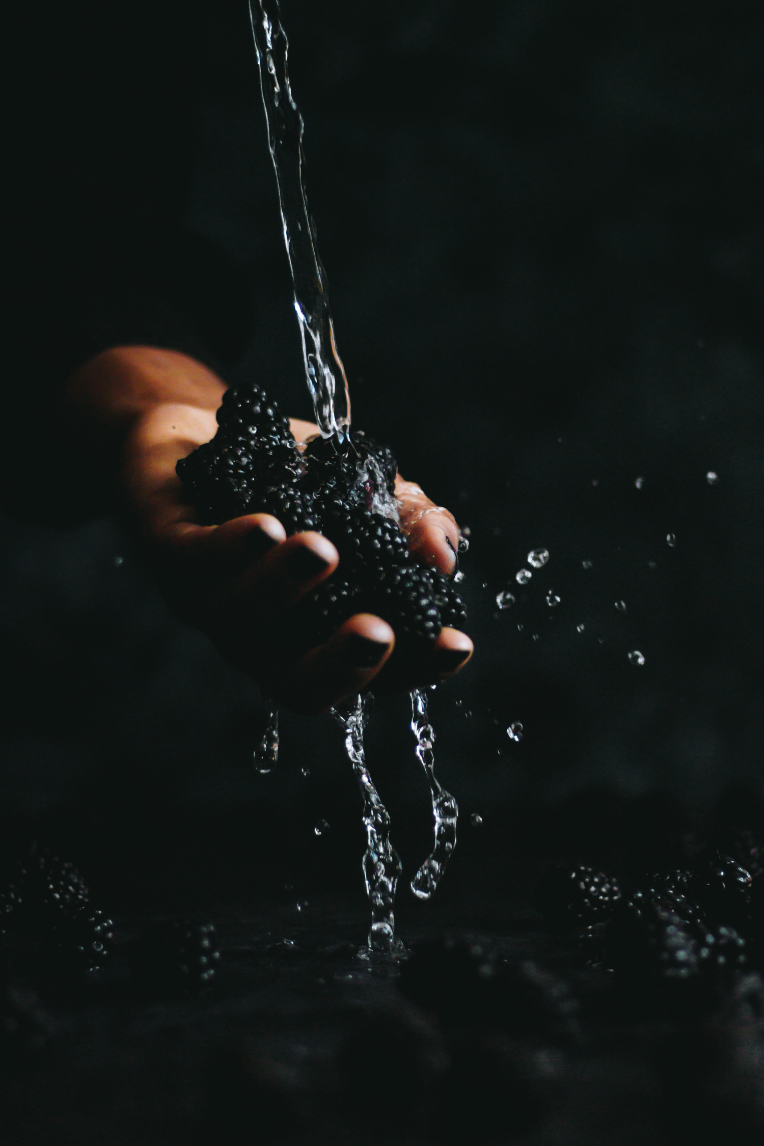 Water poured on blackberries