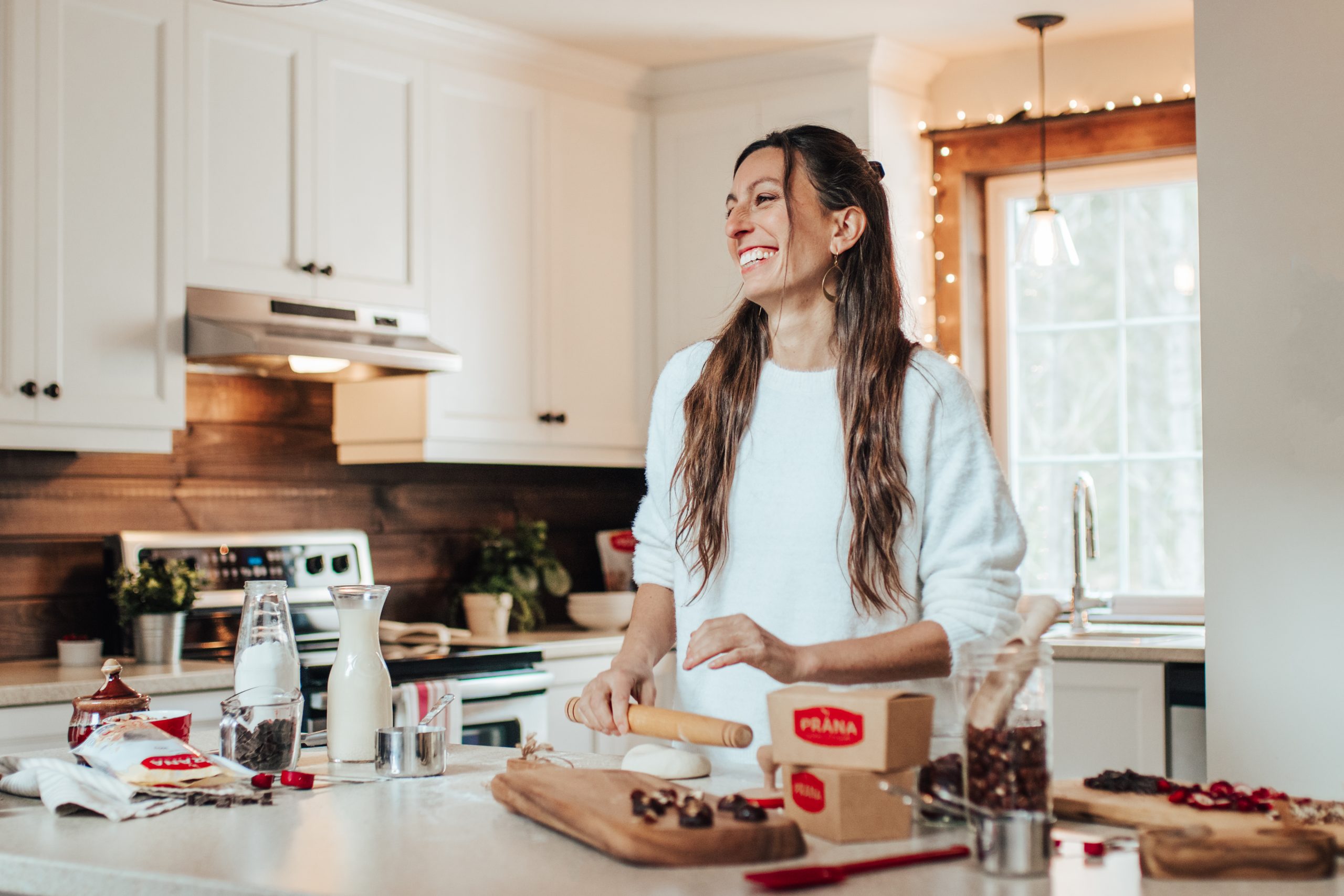 Woman in kitchen cutting cranberries