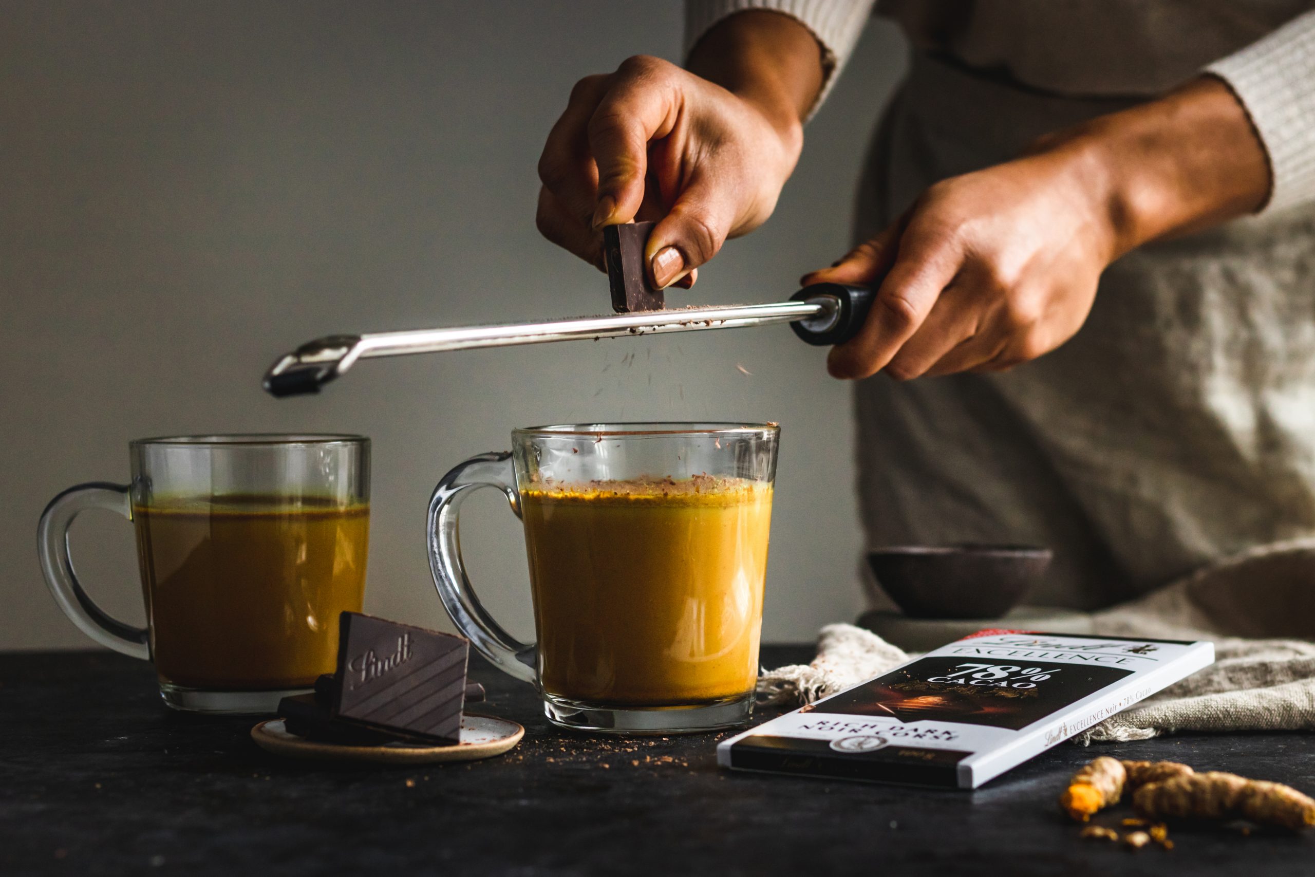 Dark chocolate grated on golden milk