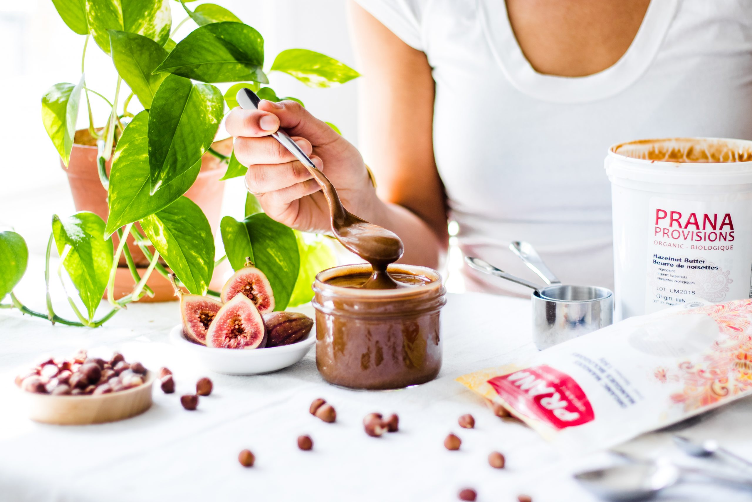 Hazelnut butter being spooned out of a jar