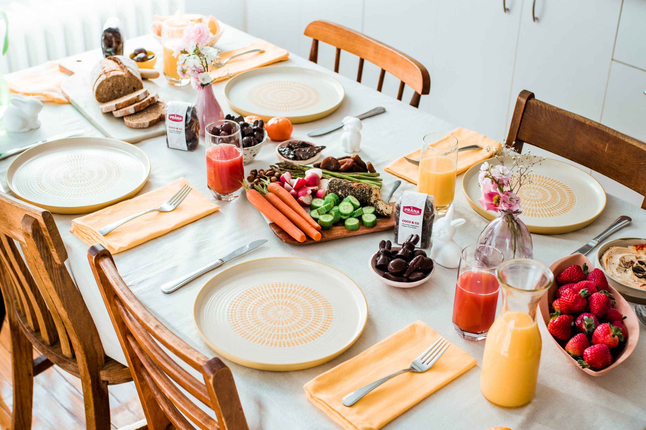 Easter Table with veggies, fresh juices, and chocolates