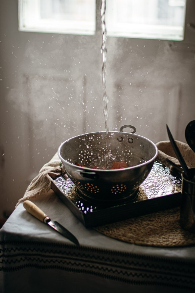 Hot water poured in colander