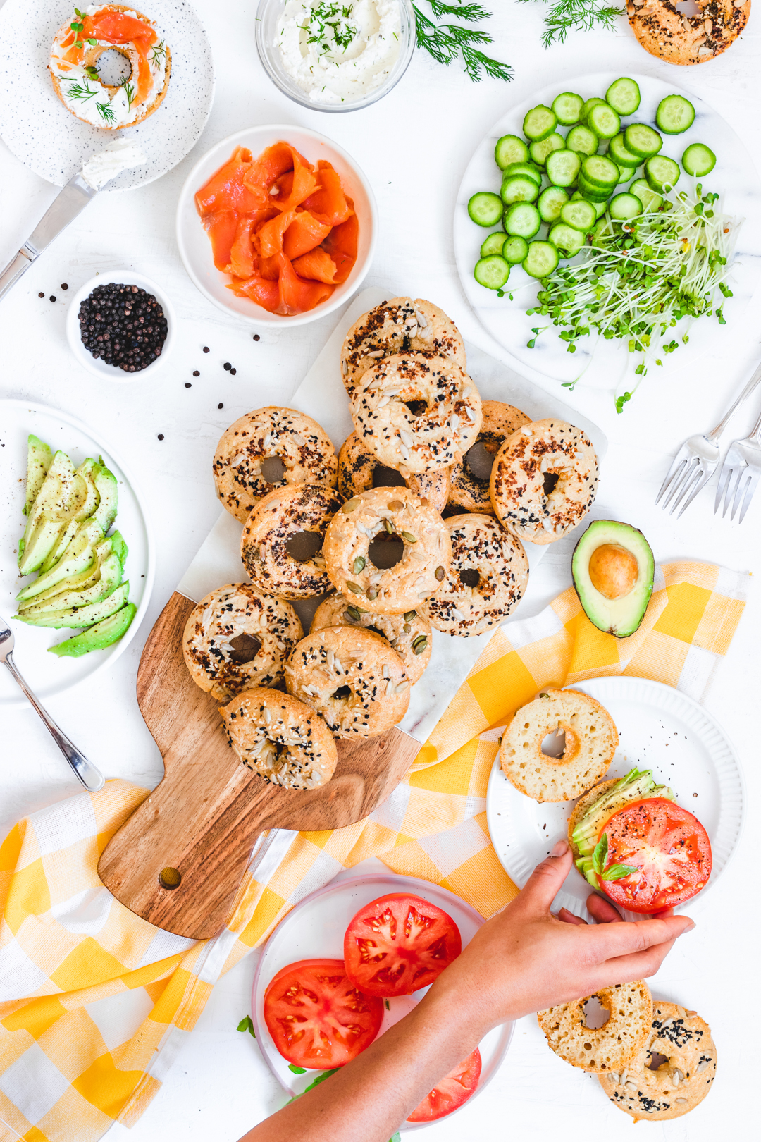 Homemade bagels surrounded by toppings