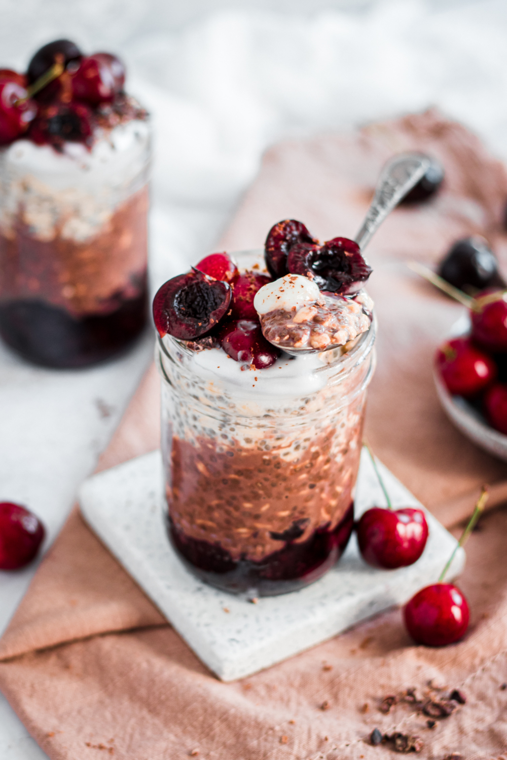 Bite taken out of layered black forest overnight oats.