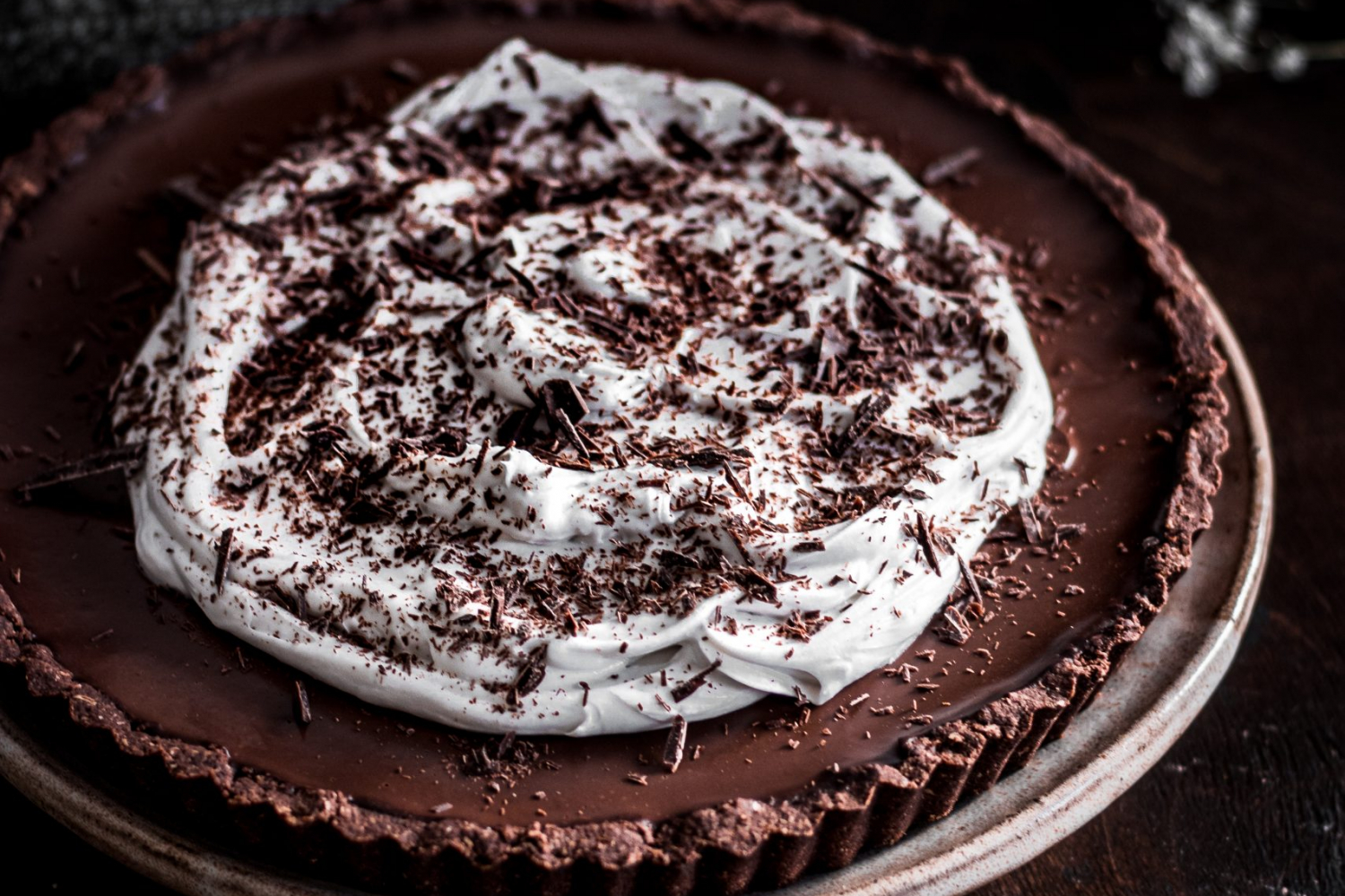 Chocolate Espresso Tart garnished with coconut whipped cream.