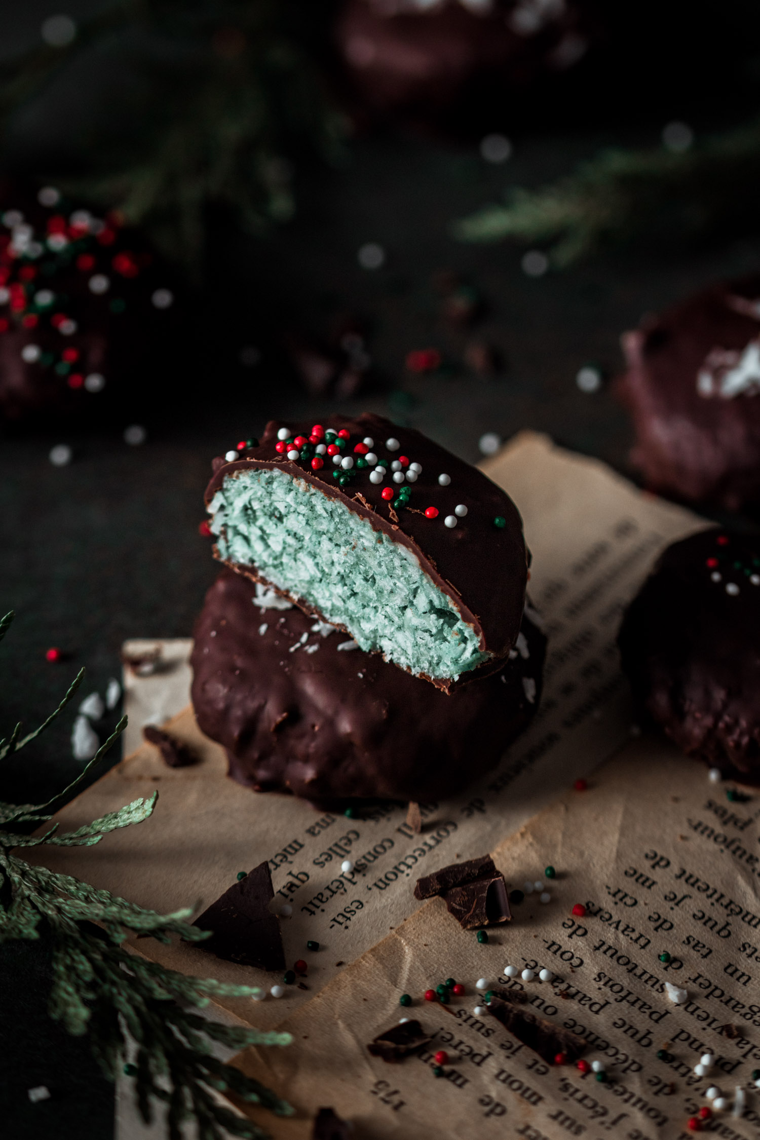 Two Chocolate Peppermint Patties Stacked with the one on top cut in half.