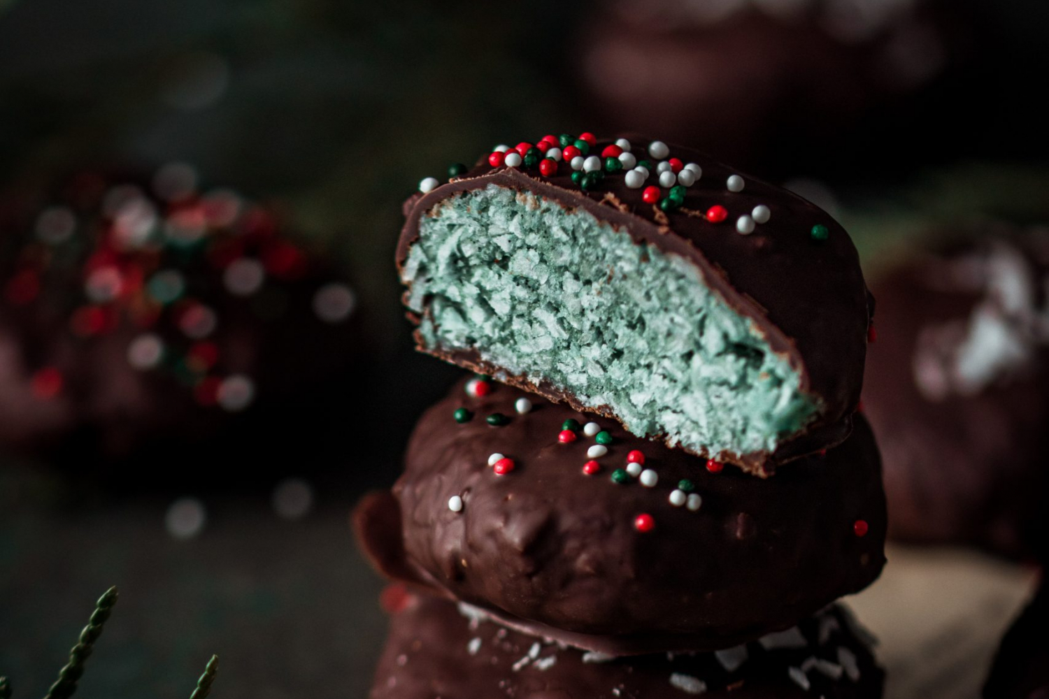 Chocolate Peppermint Patties Stacked with the one on top cut in half.