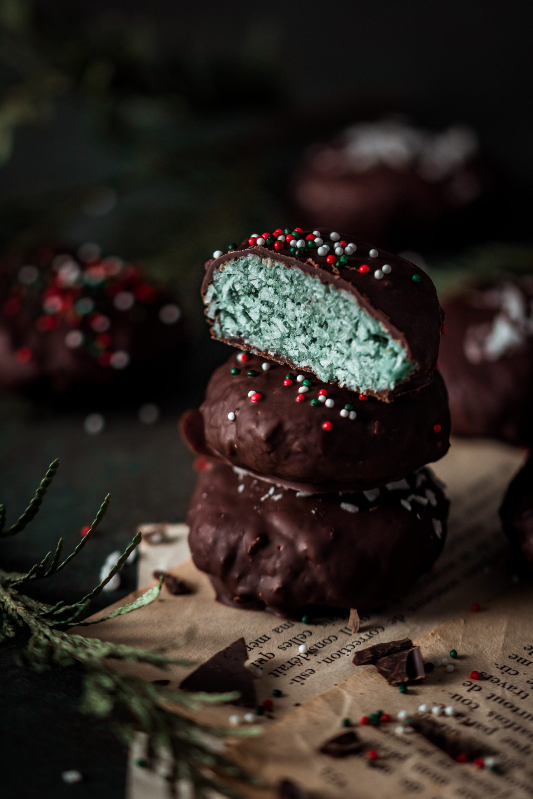 Chocolate Peppermint Patties Stacked with the one on top cut in half.