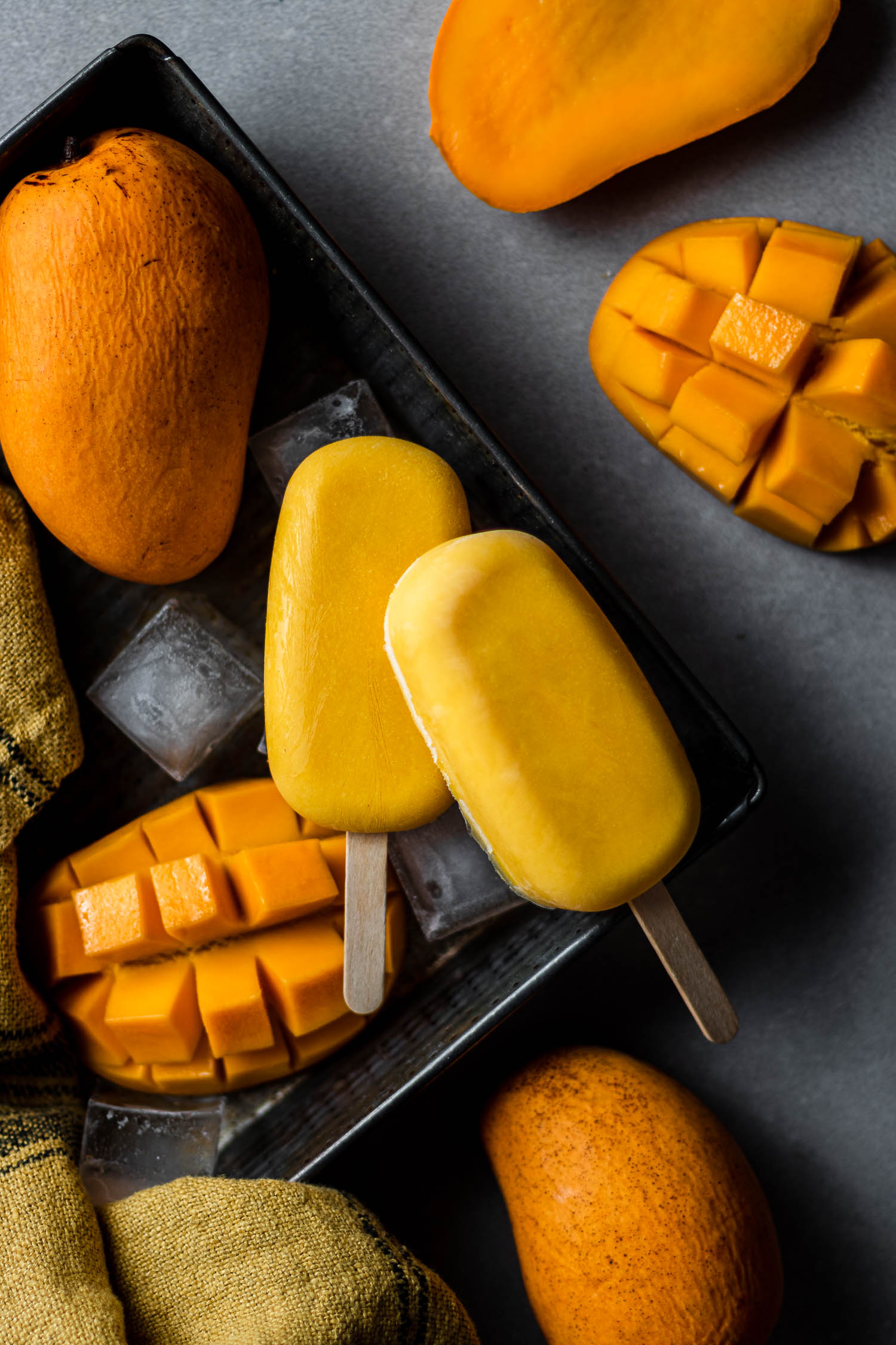 Two mango pops in a ice cube tray