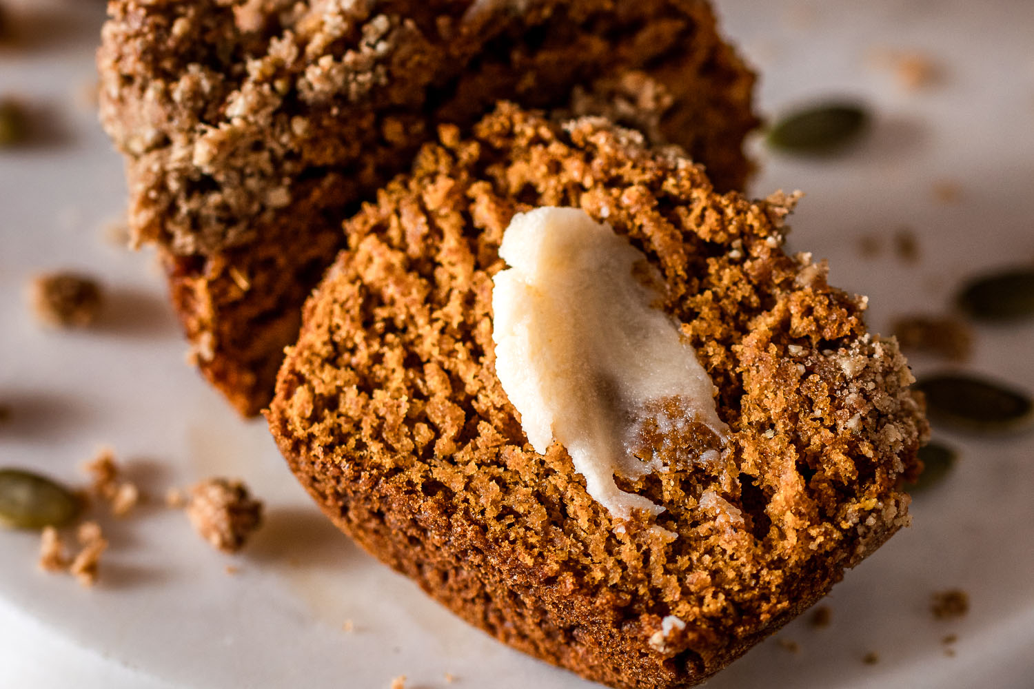 Pumpkin Muffin cut in half topped with vegan butter