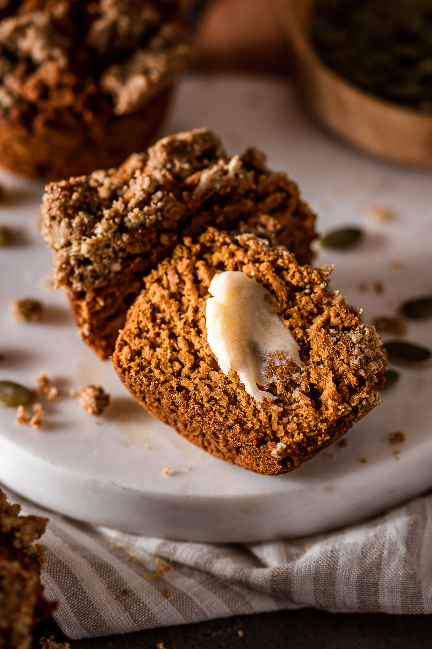 Pumpkin Muffin cut in half topped with vegan butter