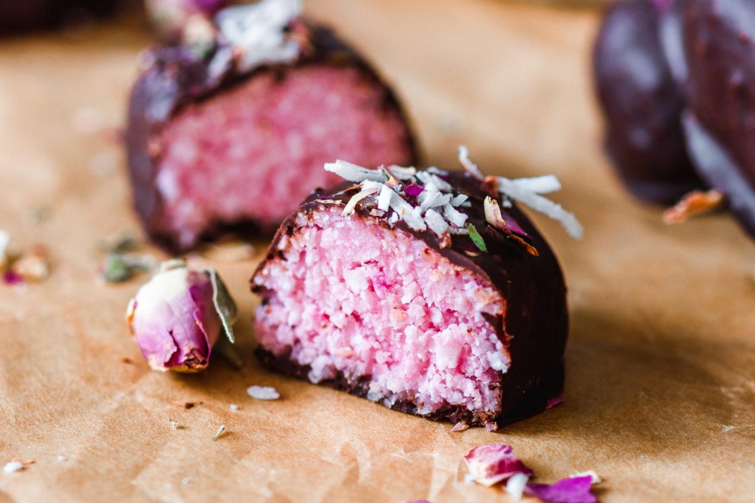 Rose Flavored Bounty Bars Cut in 2 with pink interior showing.