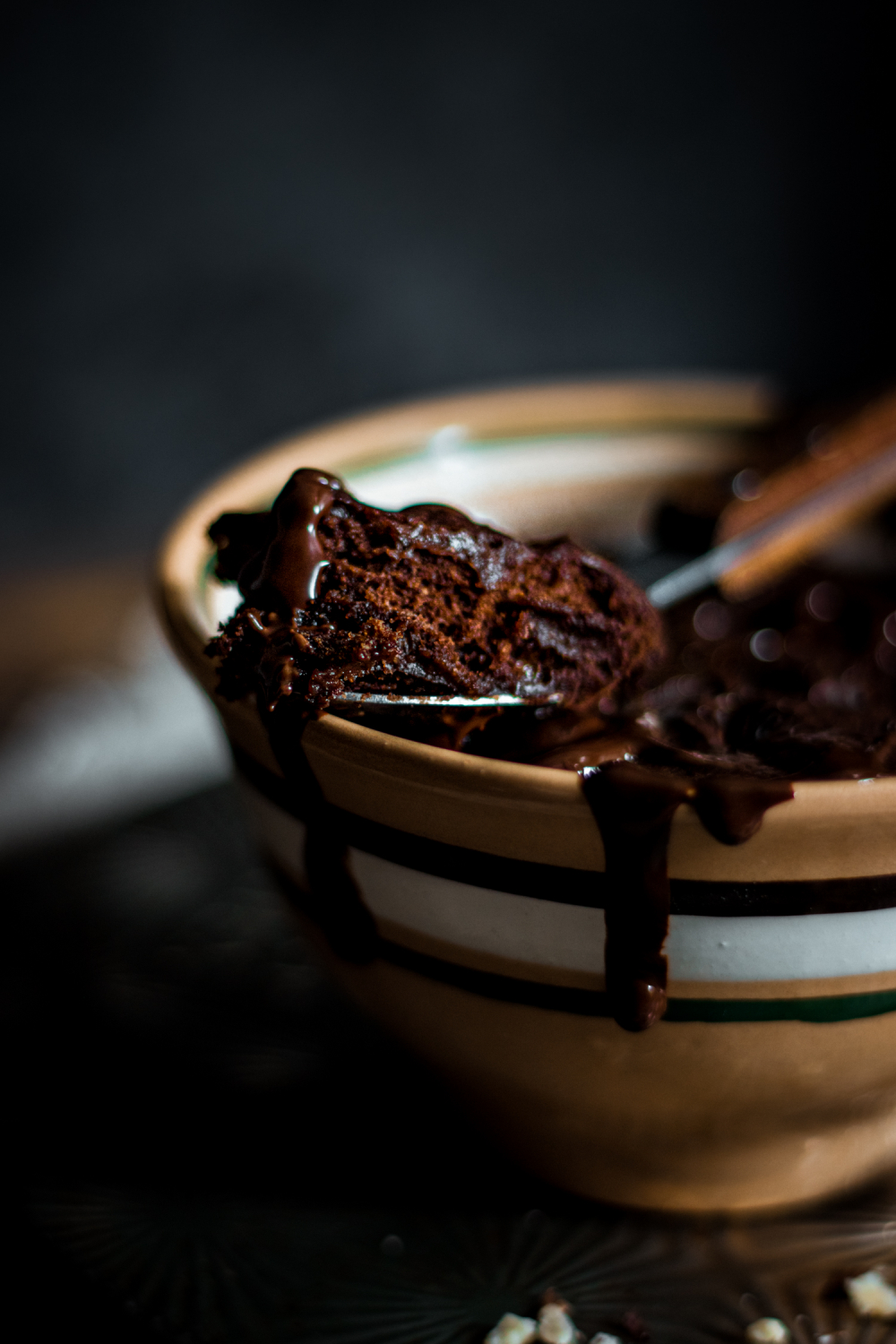 Closeup of spoonful of chocolate mug cake, with decadent texture.