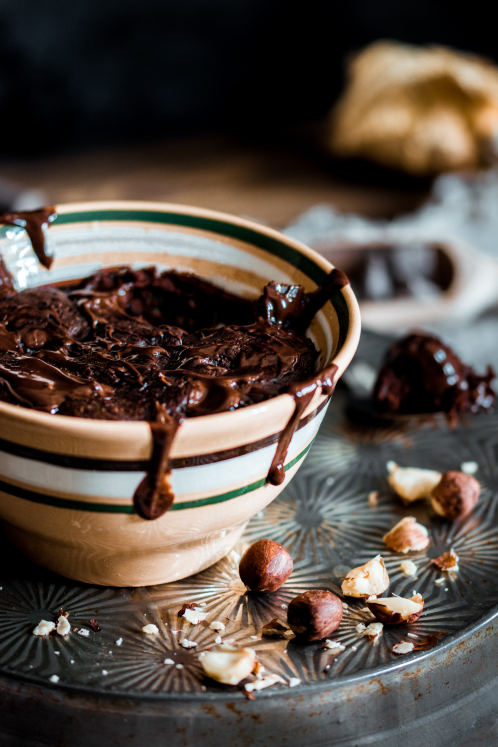 Chocolate mug cake with drips of melted chocolate going down the sides of the bowl