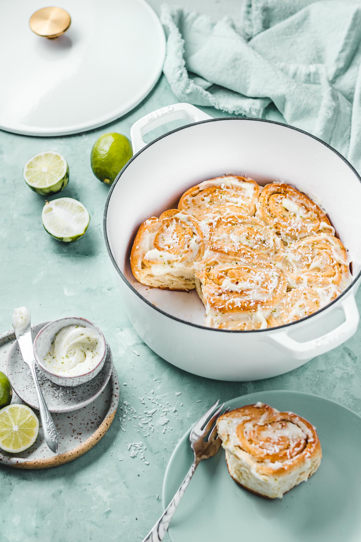 Brioche buns in Dutch oven with one taken out.