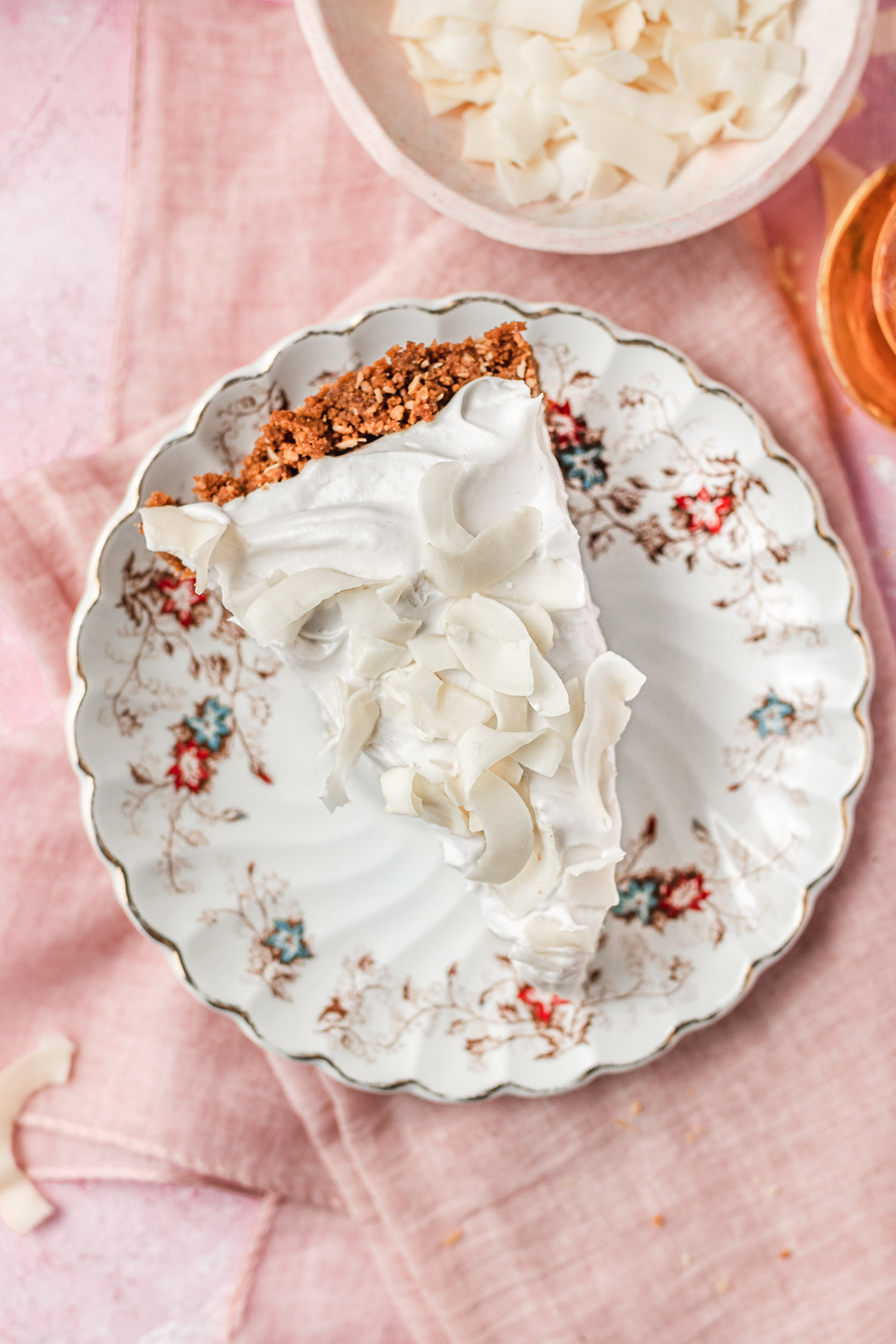 Slice of coconut rum cream pie from above on a plate