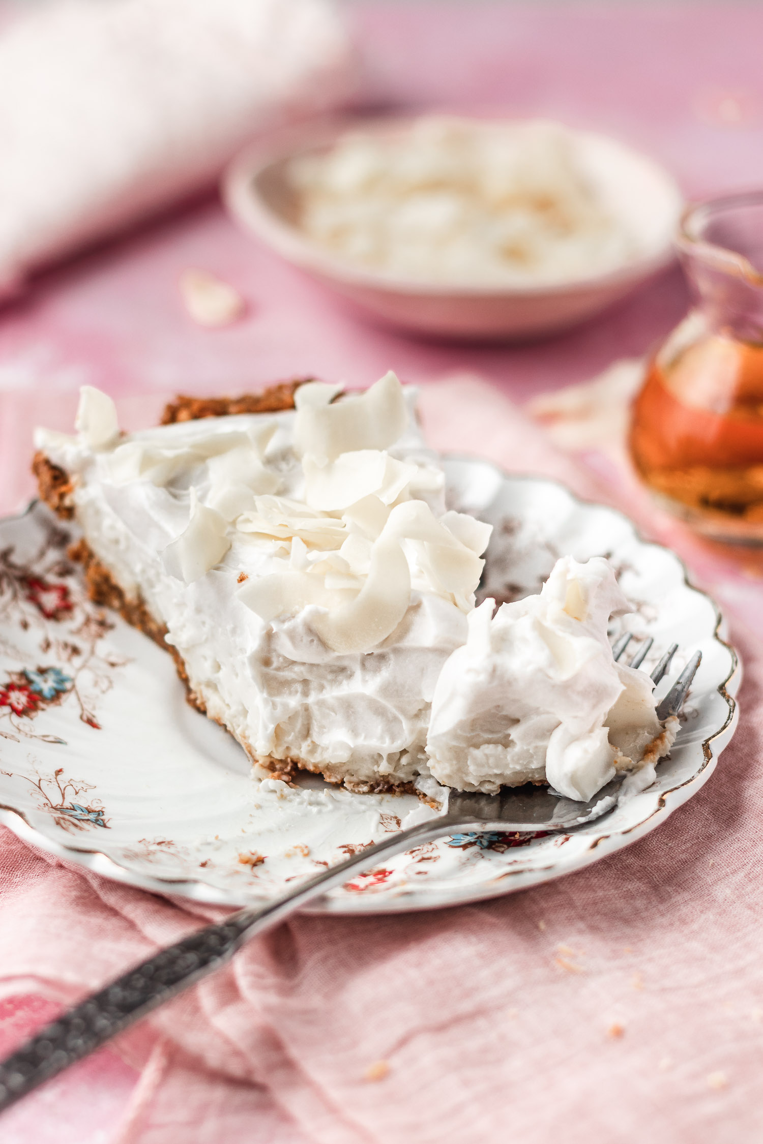 Bite taken out of coconut rum cream pie slice.