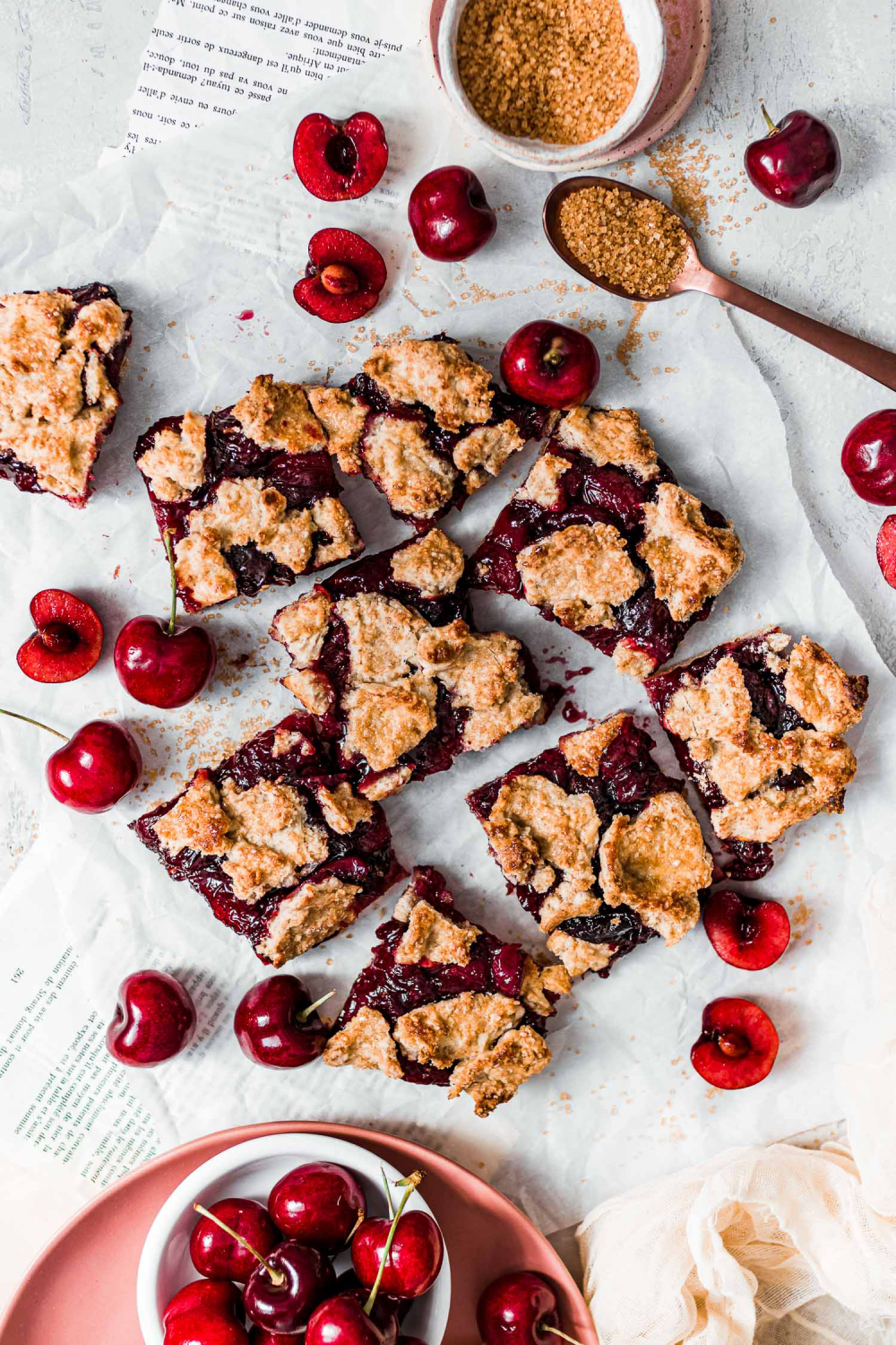 Cherry Bars scattered on a parchment paper.