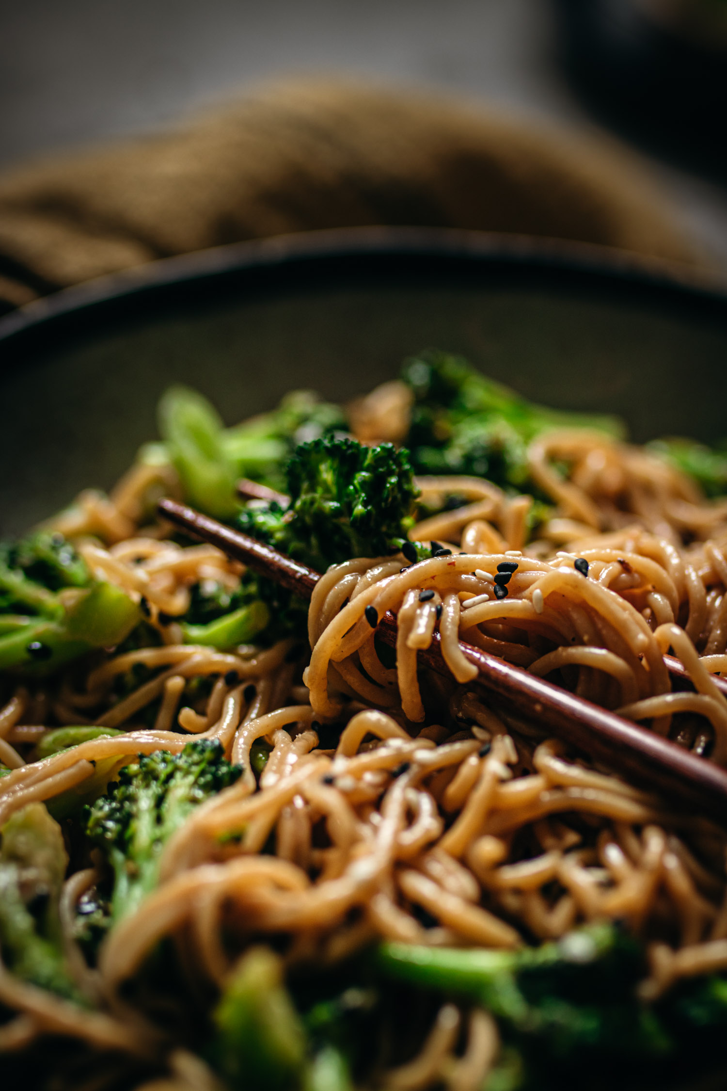 Closeup of creamy noodles around chopsticks