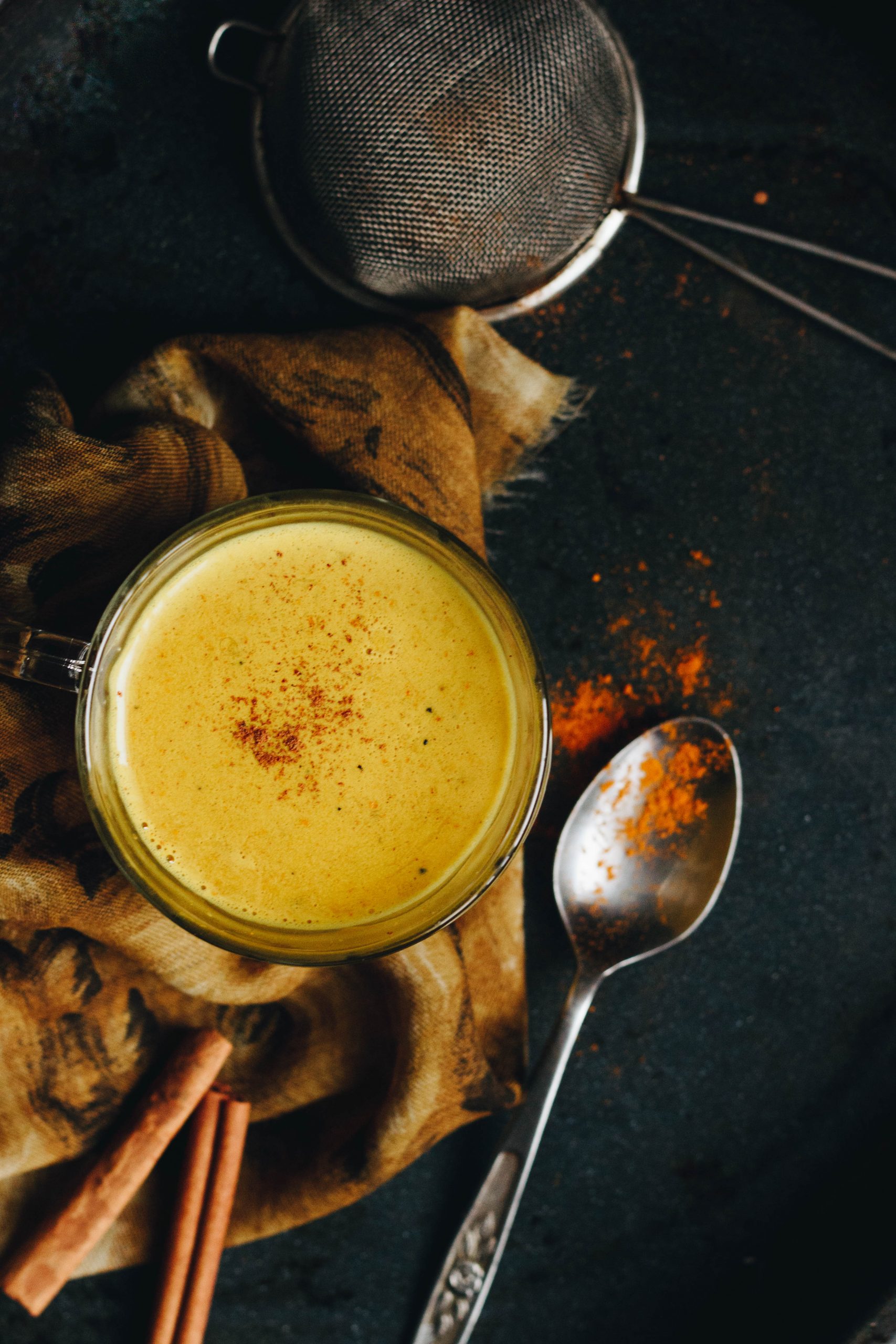 Golden milk topped with ground cinnamon