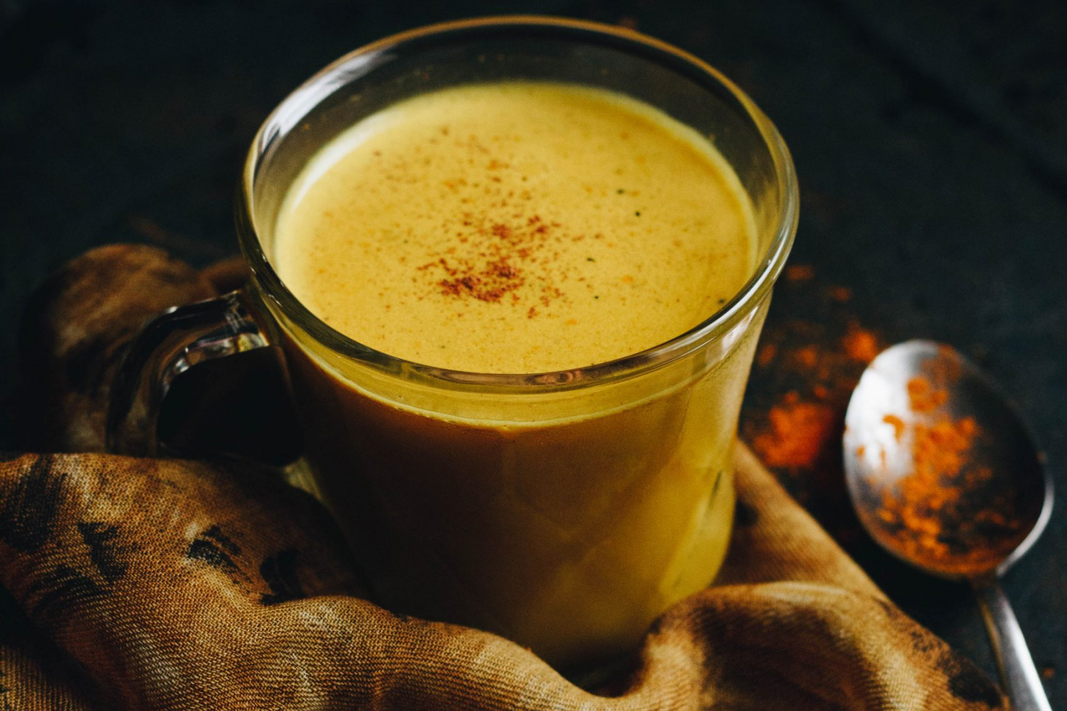 Golden milk in a cup with a sprinkle of cinnamon