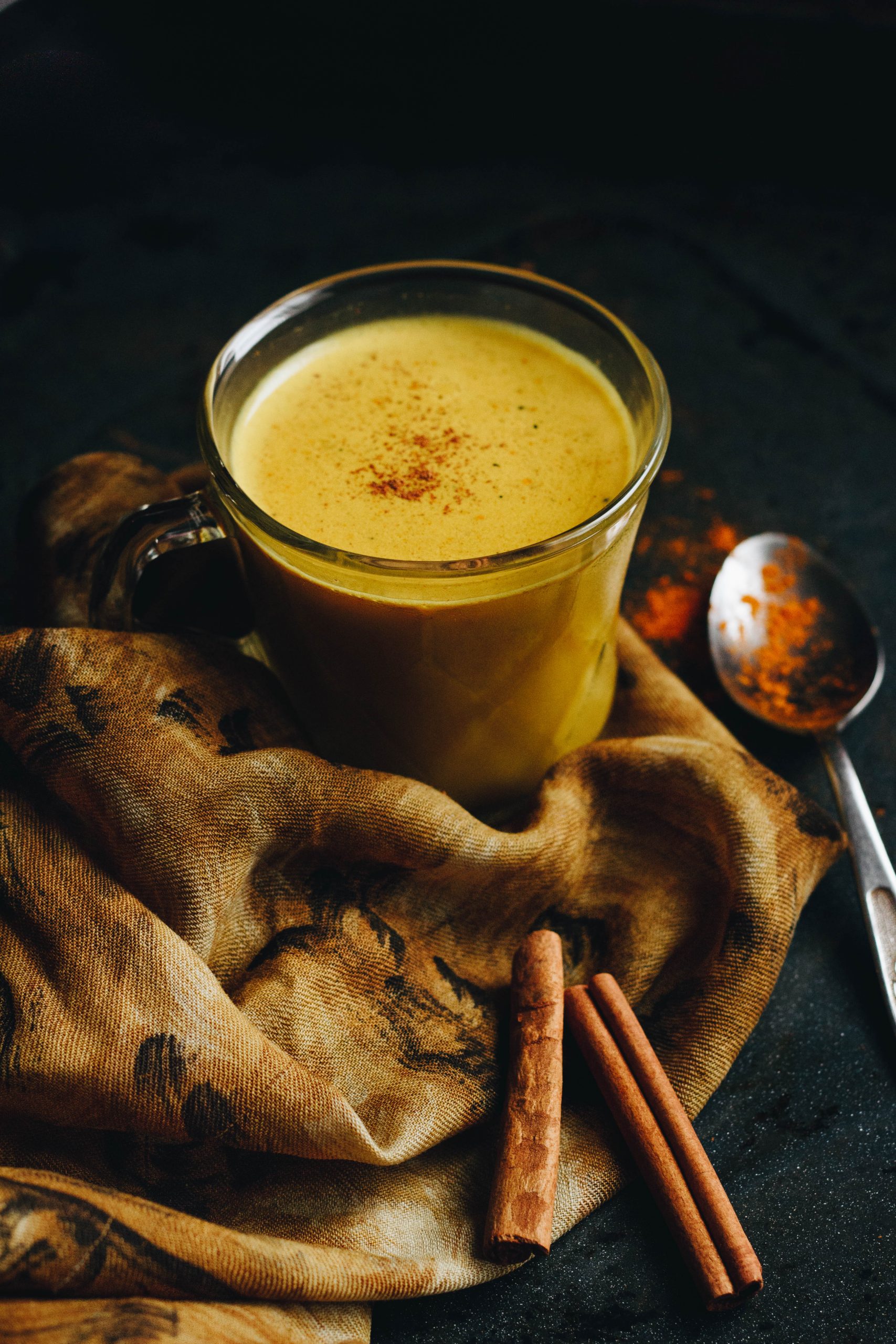 Golden milk in a cup with a sprinkle of cinnamon