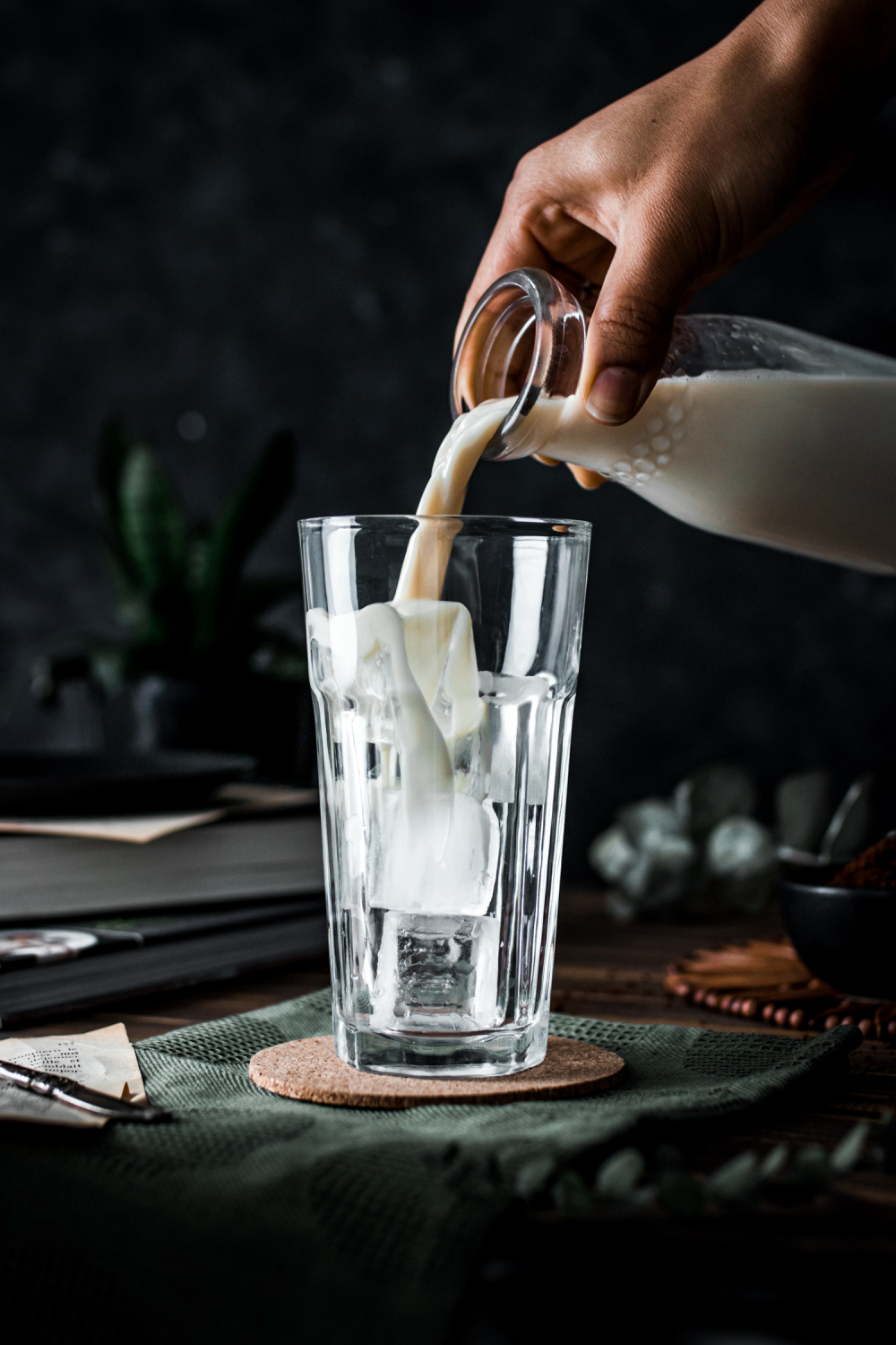 Milk poured in a glass with ice