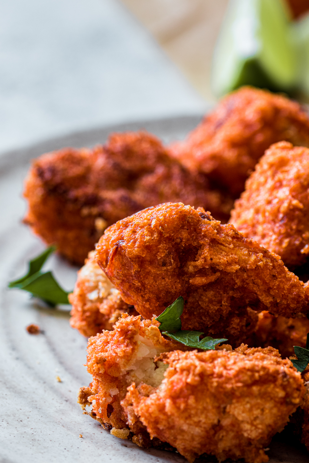 Panko crusted cauliflower on a small plate garnished with fresh parsley