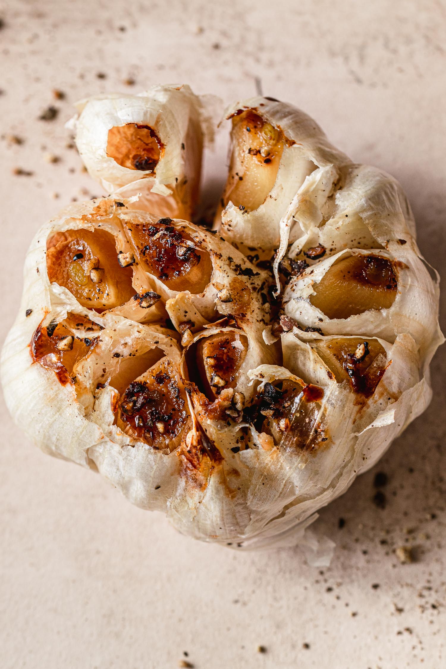 Oven roasted garlic open. Interior cloves visible.