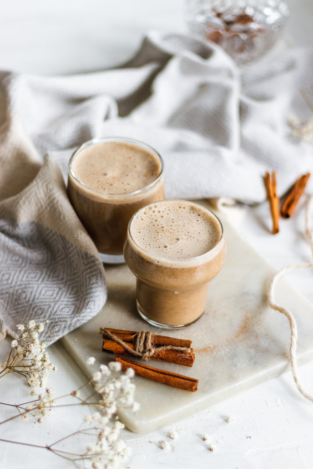 Two spiced almond lattes on a cutting board