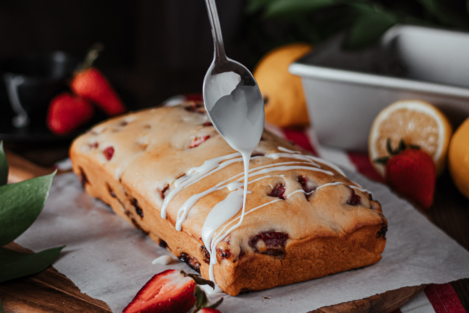 Strawberry Loaf being drizzled with its icing.