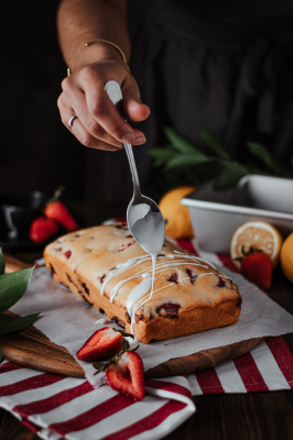 Strawberry Loaf being drizzled with its icing.