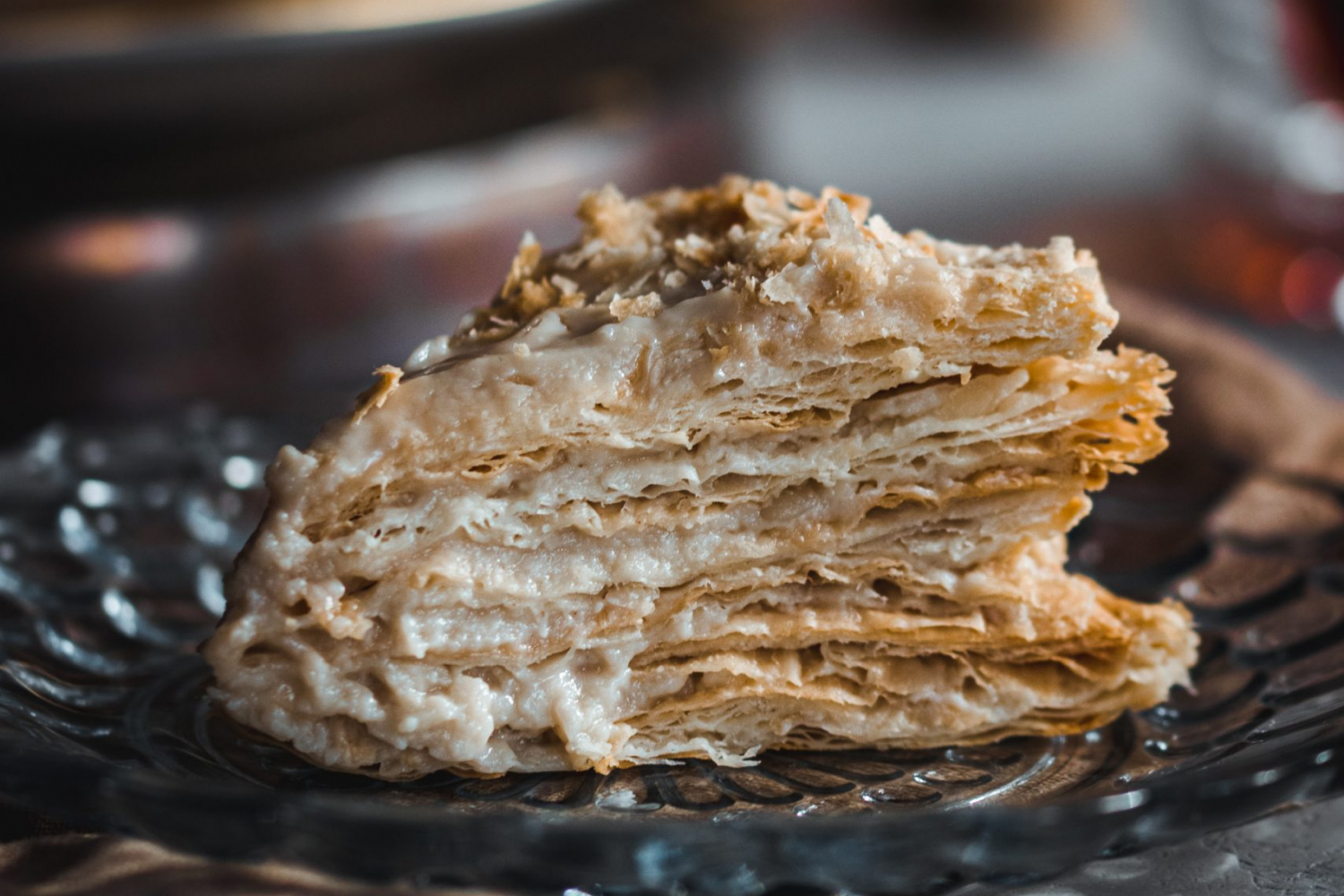 Slice of vegan napoleon cake on a glass plate