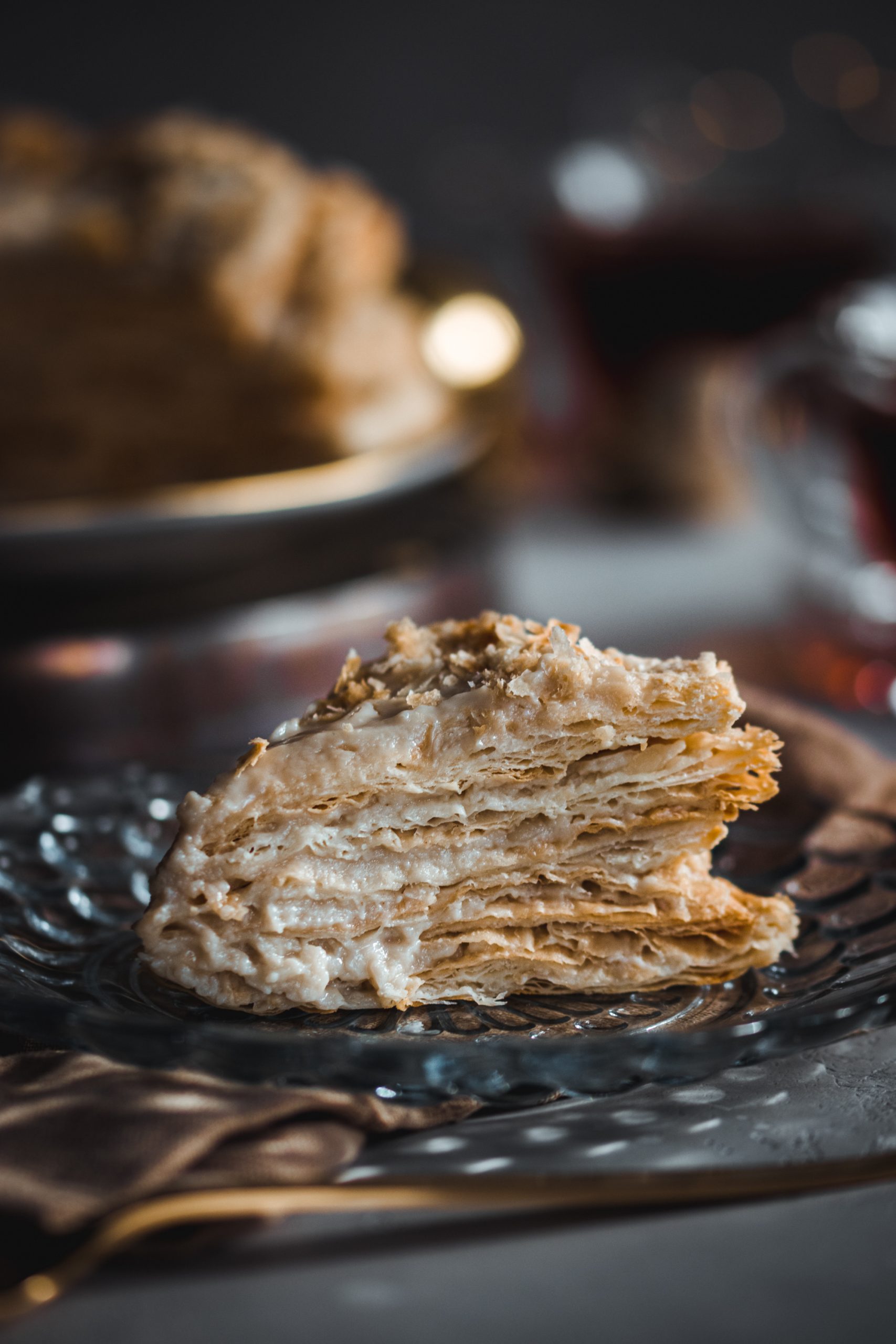 Slice of vegan napoleon cake on a glass plate