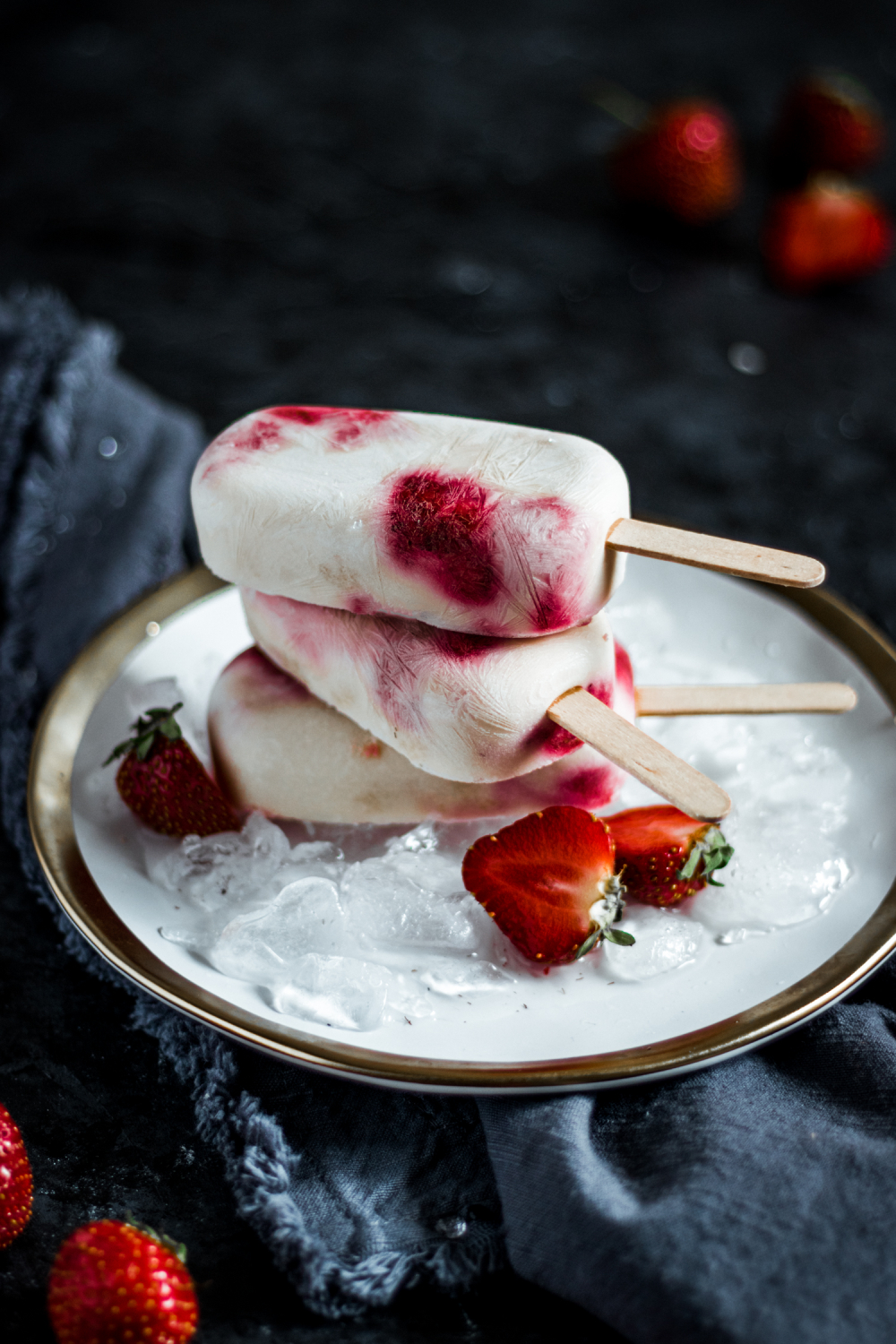 3 Strawberry shortcake pops stacked on a plate