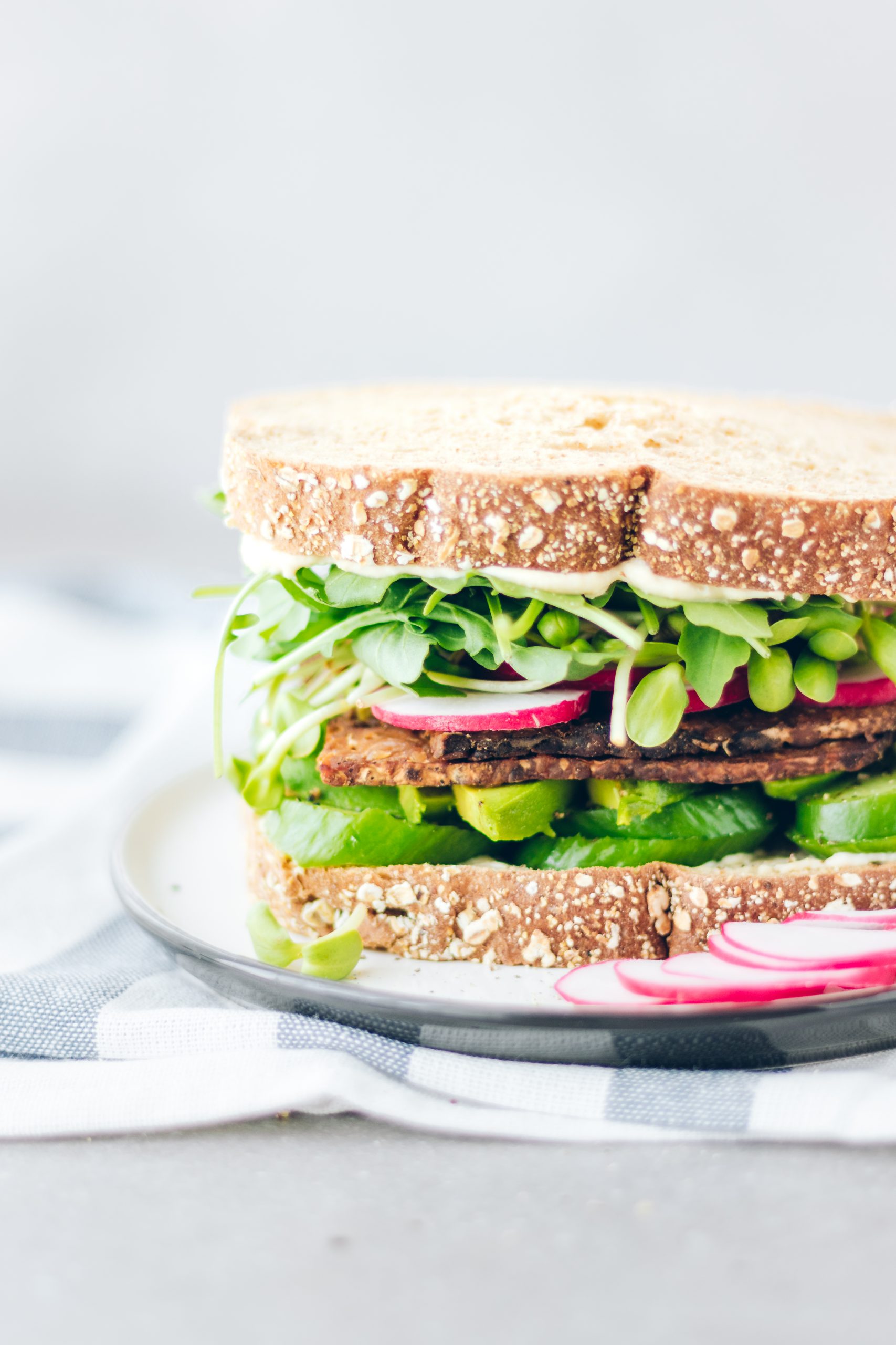 Closeup of Spring Sandwich with Tempeh Bacon, Arugula and Broccoli Sprouts