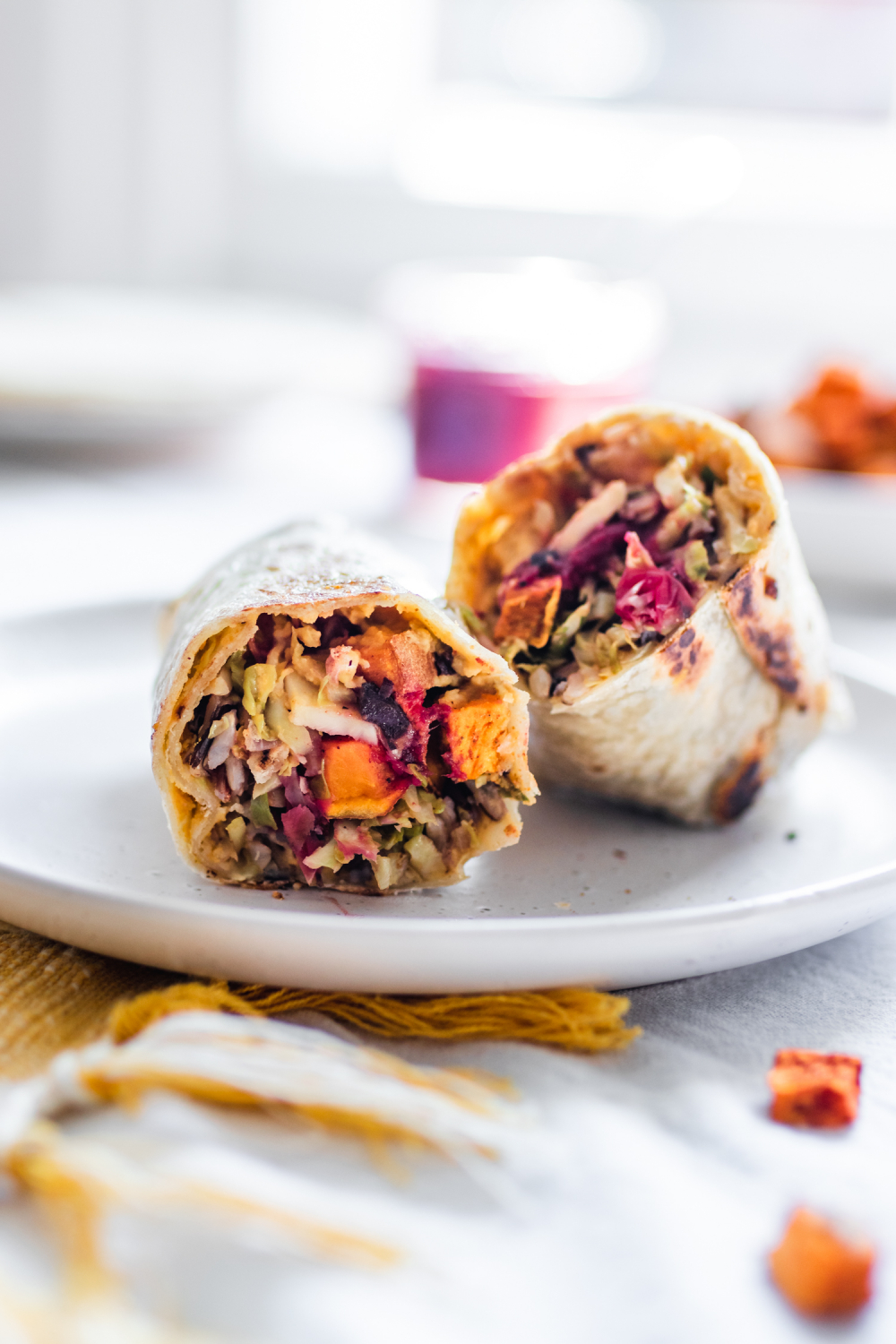 Vegan wrap cut in half, stuffed with squash, brussels sprouts, cranberries, sweet potatoes block-cover-recipe apples