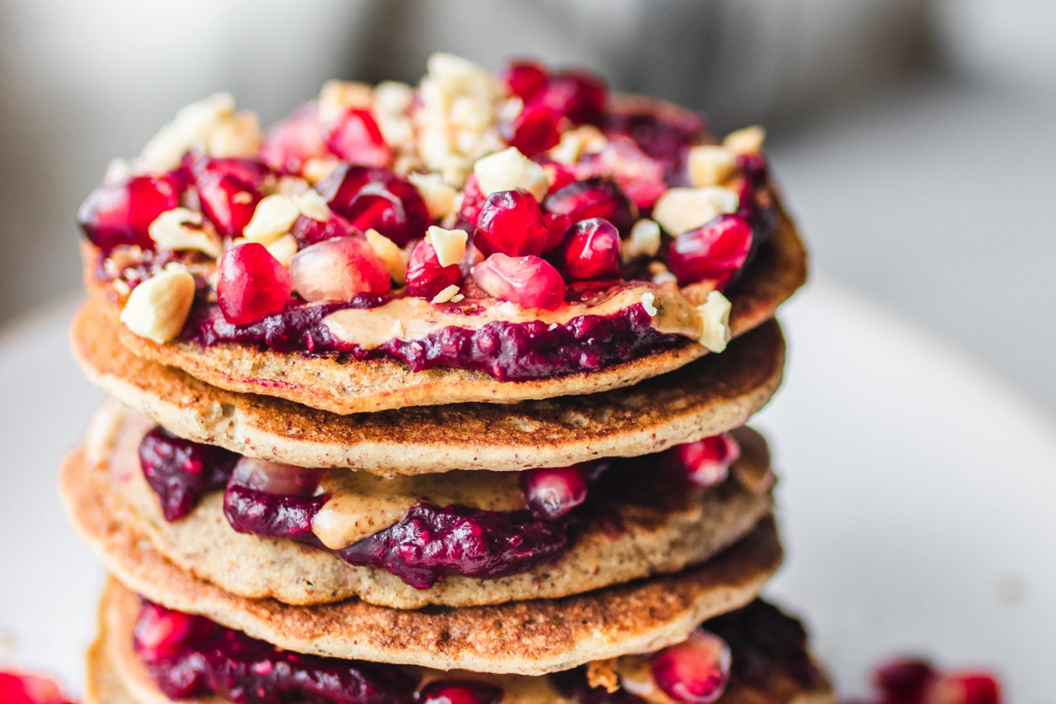 The Fluffiest Gluten Free Sugar Free Pancakes Stacked with berries and nut butter