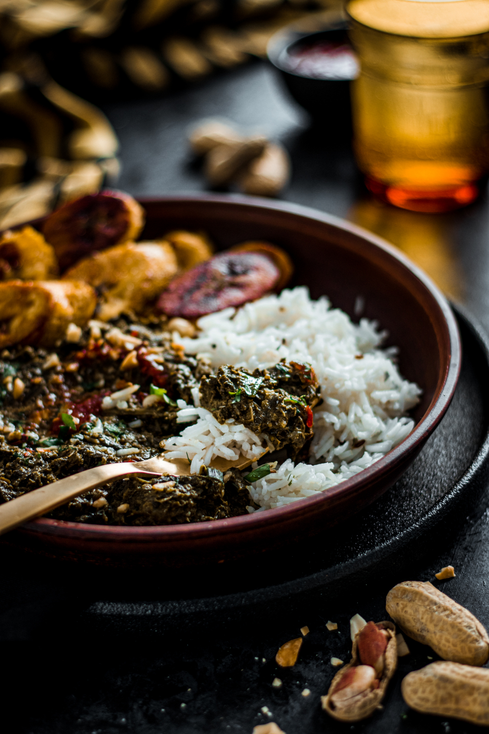 Vegan Saka Saka served with white rice plantains and spicy sauce