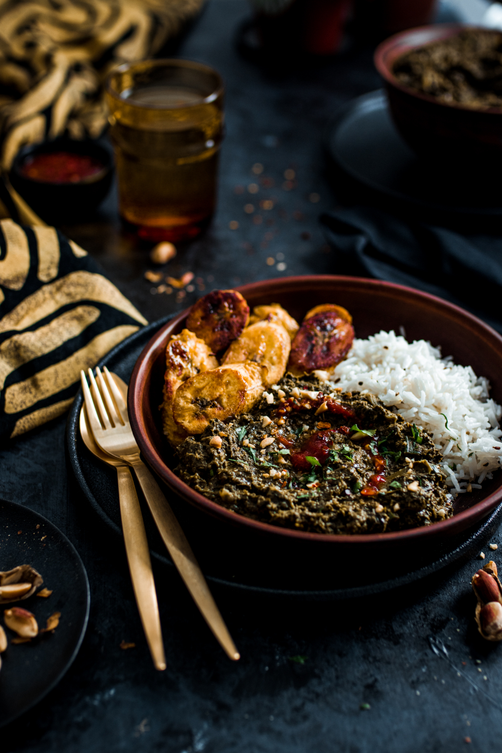 Vegan Saka Saka served with white rice plantains and spicy sauce