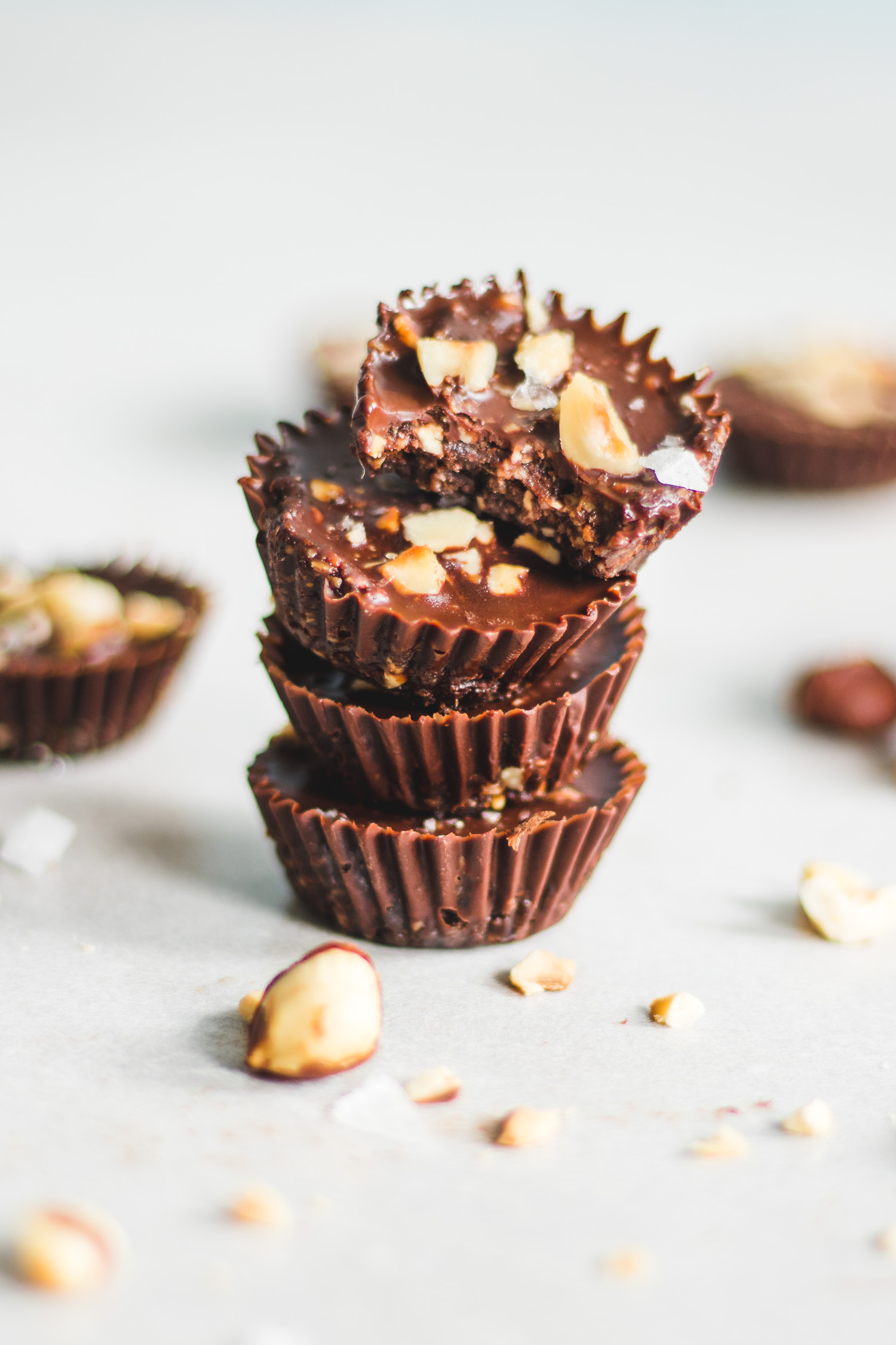 Decadent Chocolate and Hazelnut Cups stacked with bite taken out of one