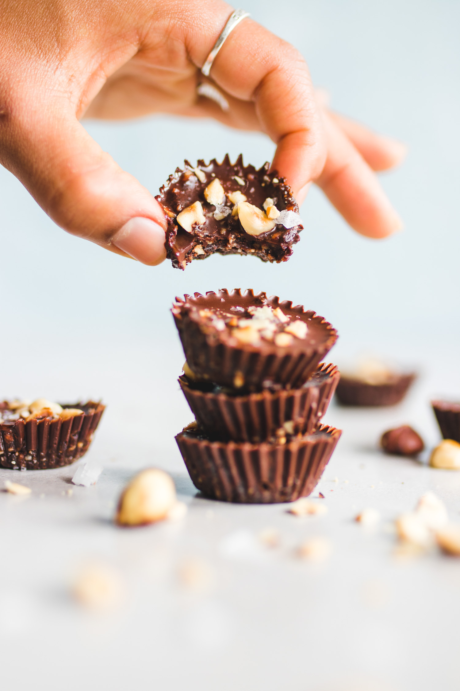 Decadent Chocolate and Hazelnut Cups with hand grabbing one