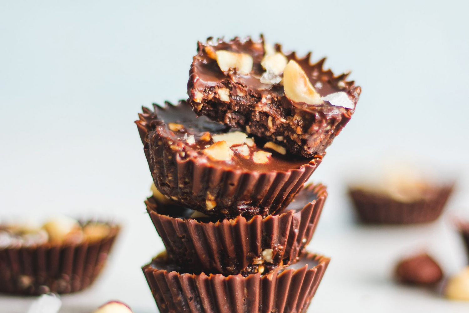 Decadent Chocolate and Hazelnut Cups Stacked with Bite Taken out of one