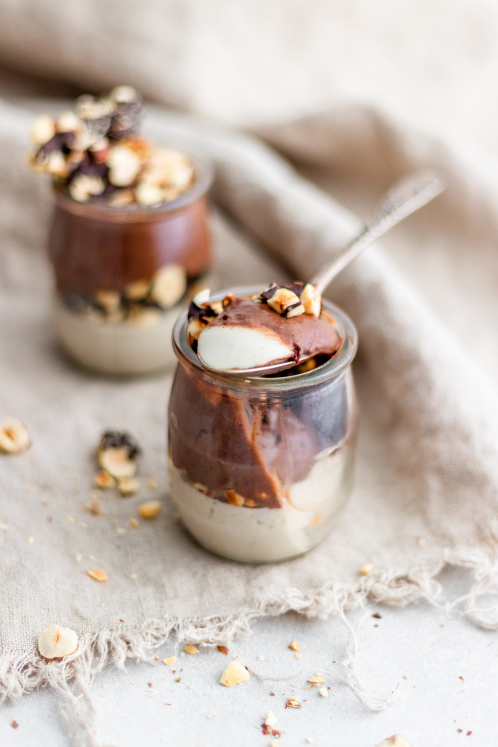 Coconut Panna Cotta with Chocolate Mousse and Hazelnut Crunch with spoon taken out