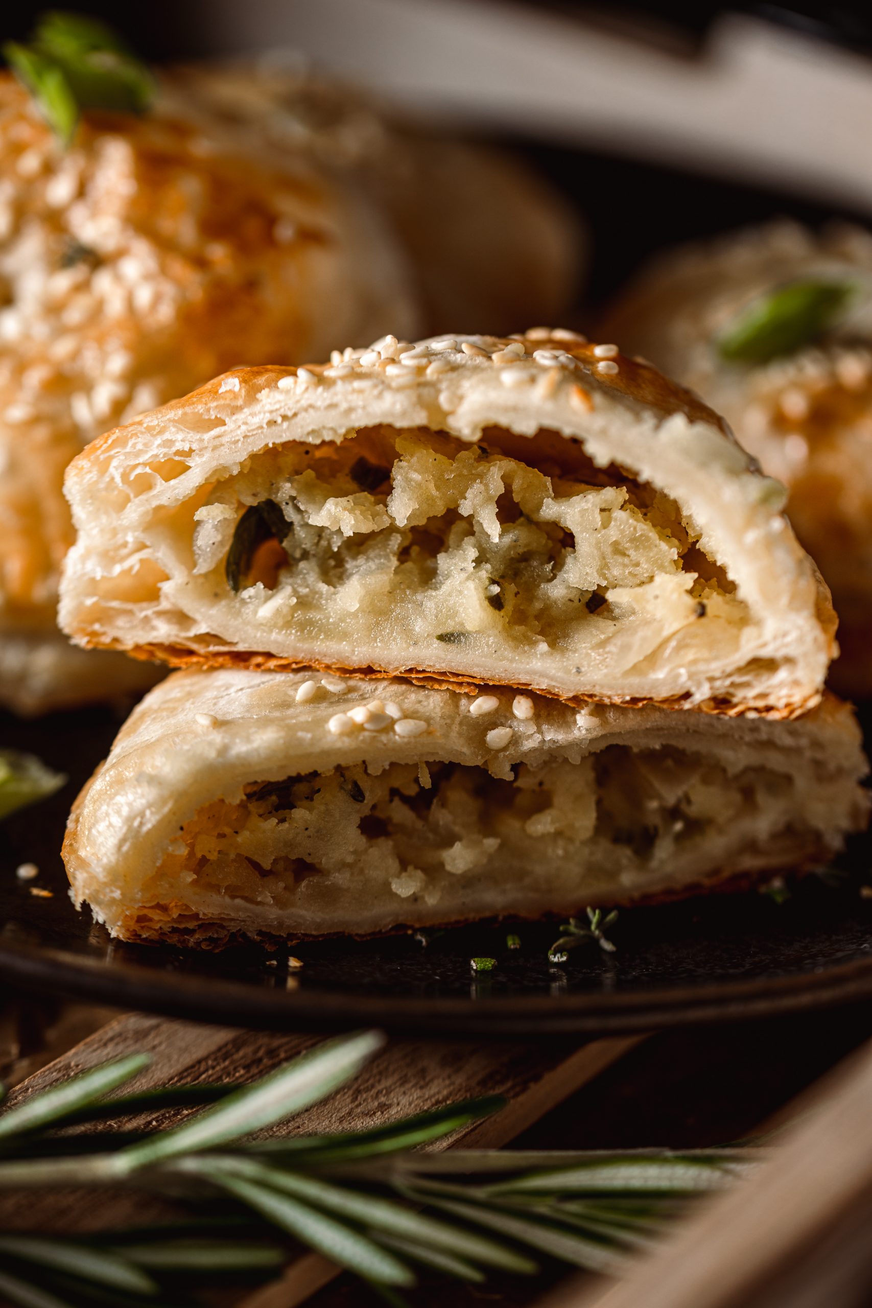 Potato Onion Hand Pies sliced in half with filling shown