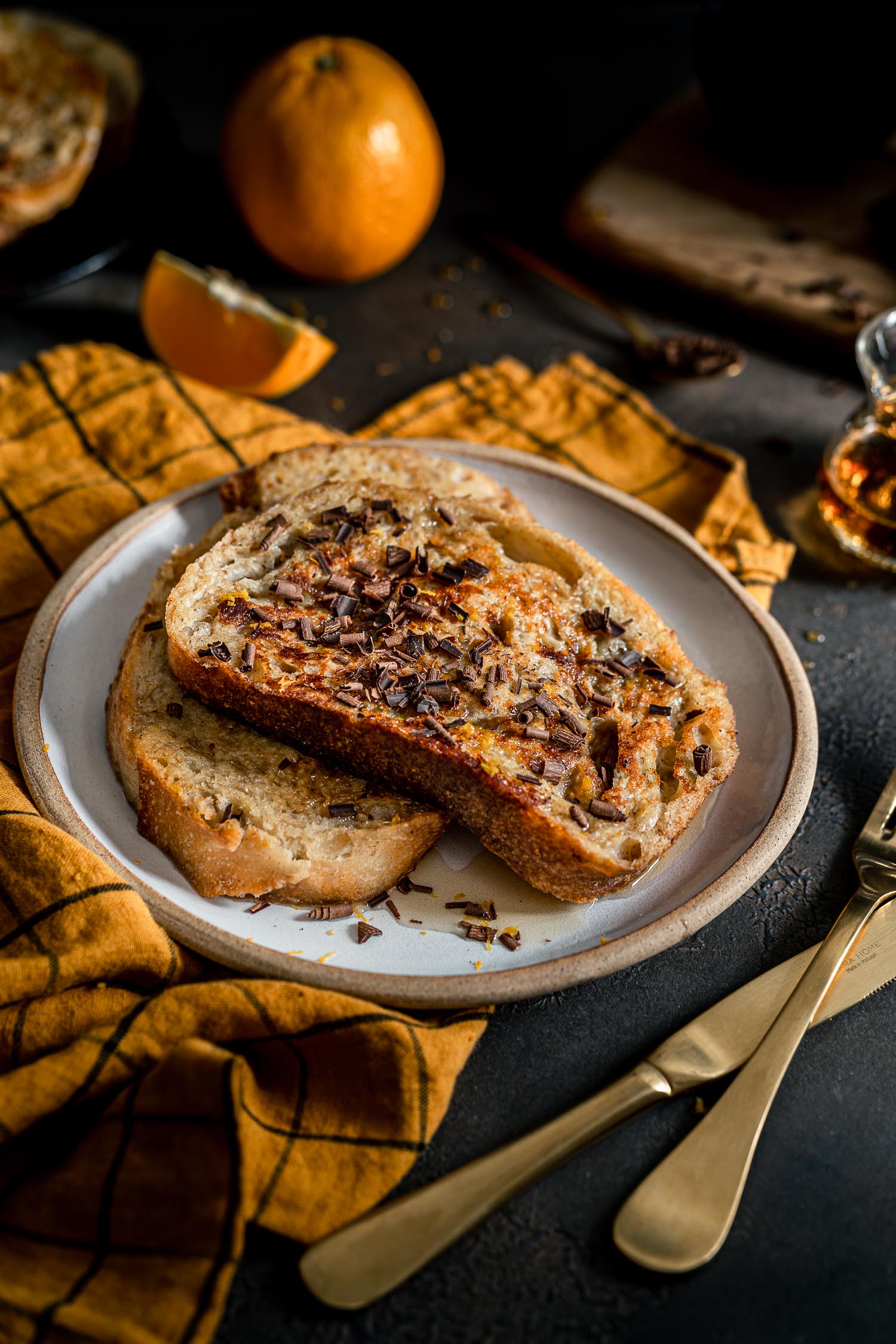 Grand Marnier French Toast in a plate with maple syrup and chocolate shavings.