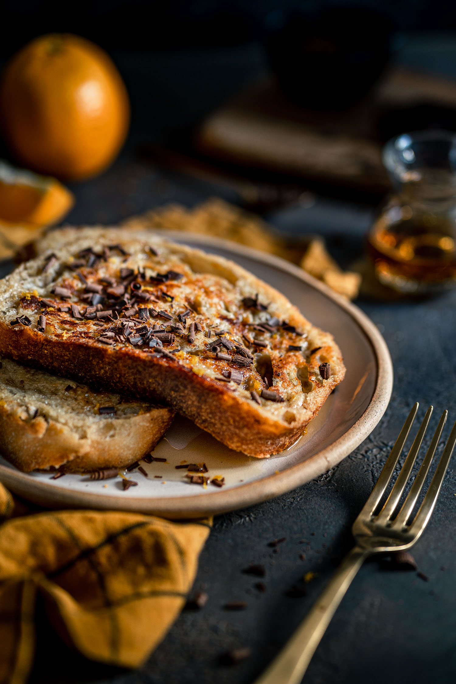 Grand Marnier French Toast in a plate with maple syrup and chocolate shavings.