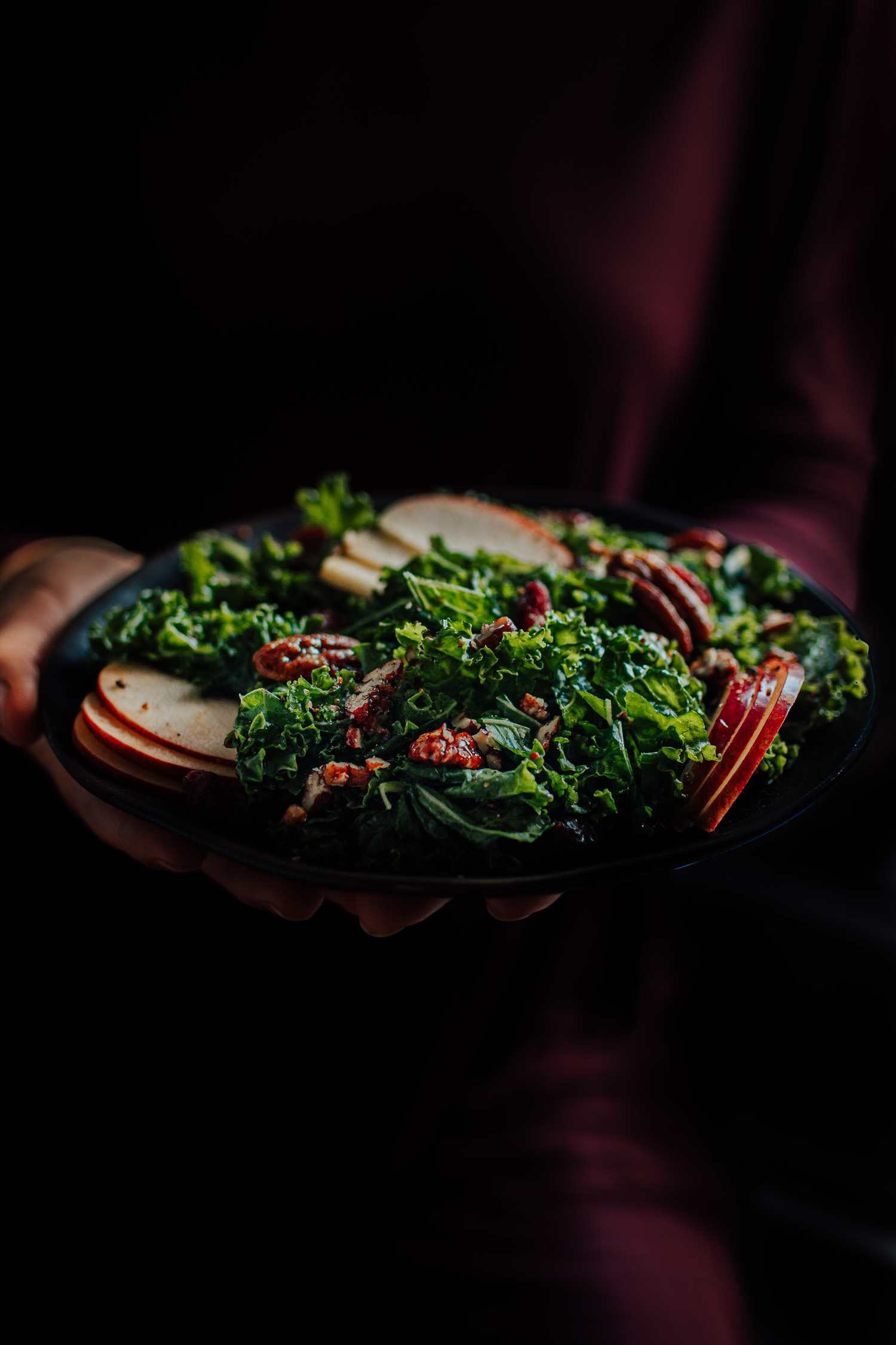Candied Pecan Kale Salad held in hands