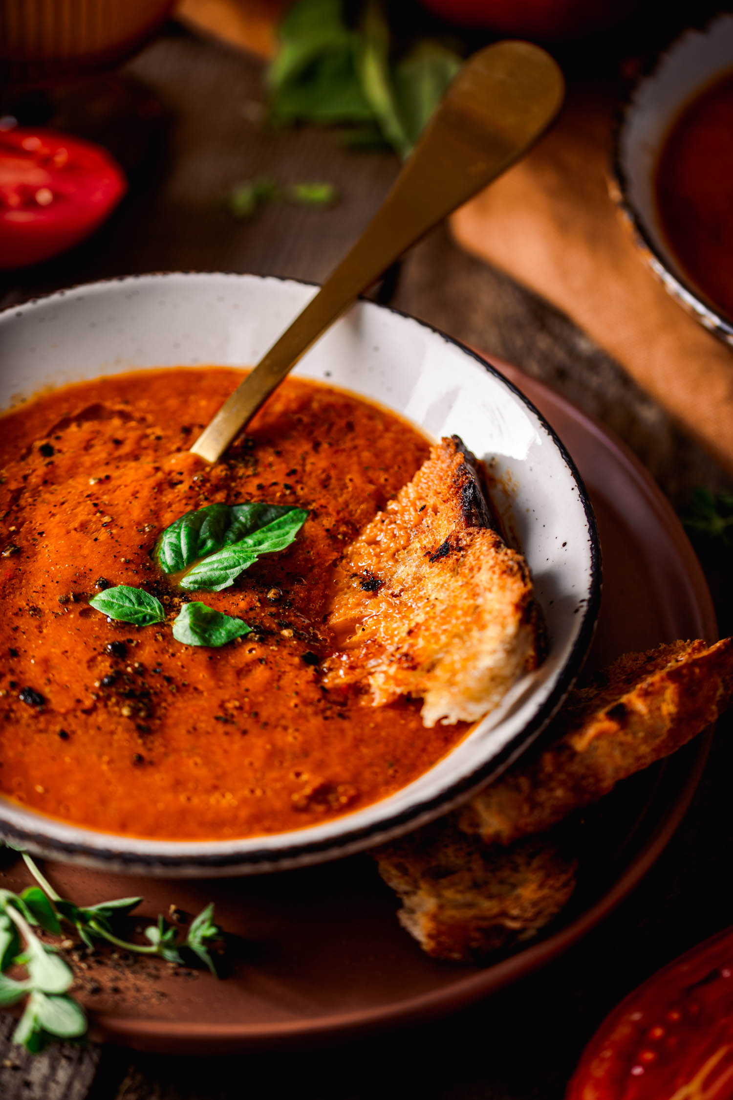 Roasted Tomato and Bell Pepper Soup with toasted bread inside the bowl